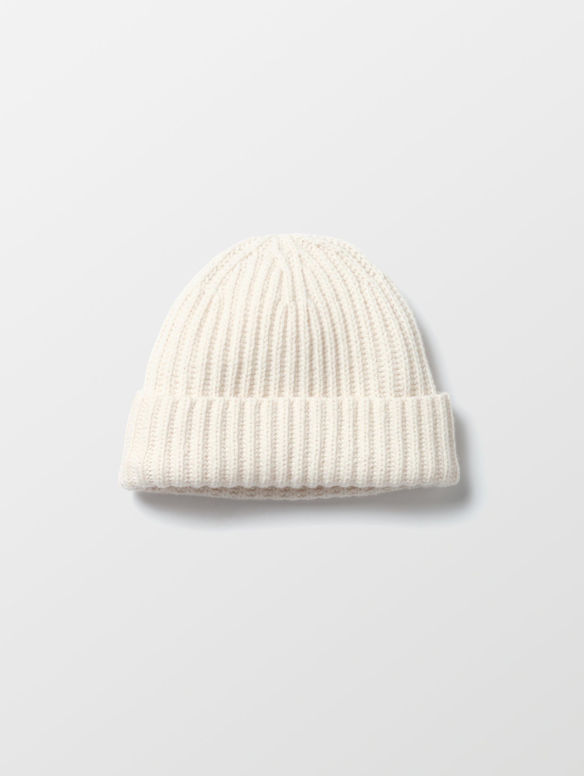 Flat lay of the Cashmere Hat in Winter White from AETHER Apparel. 