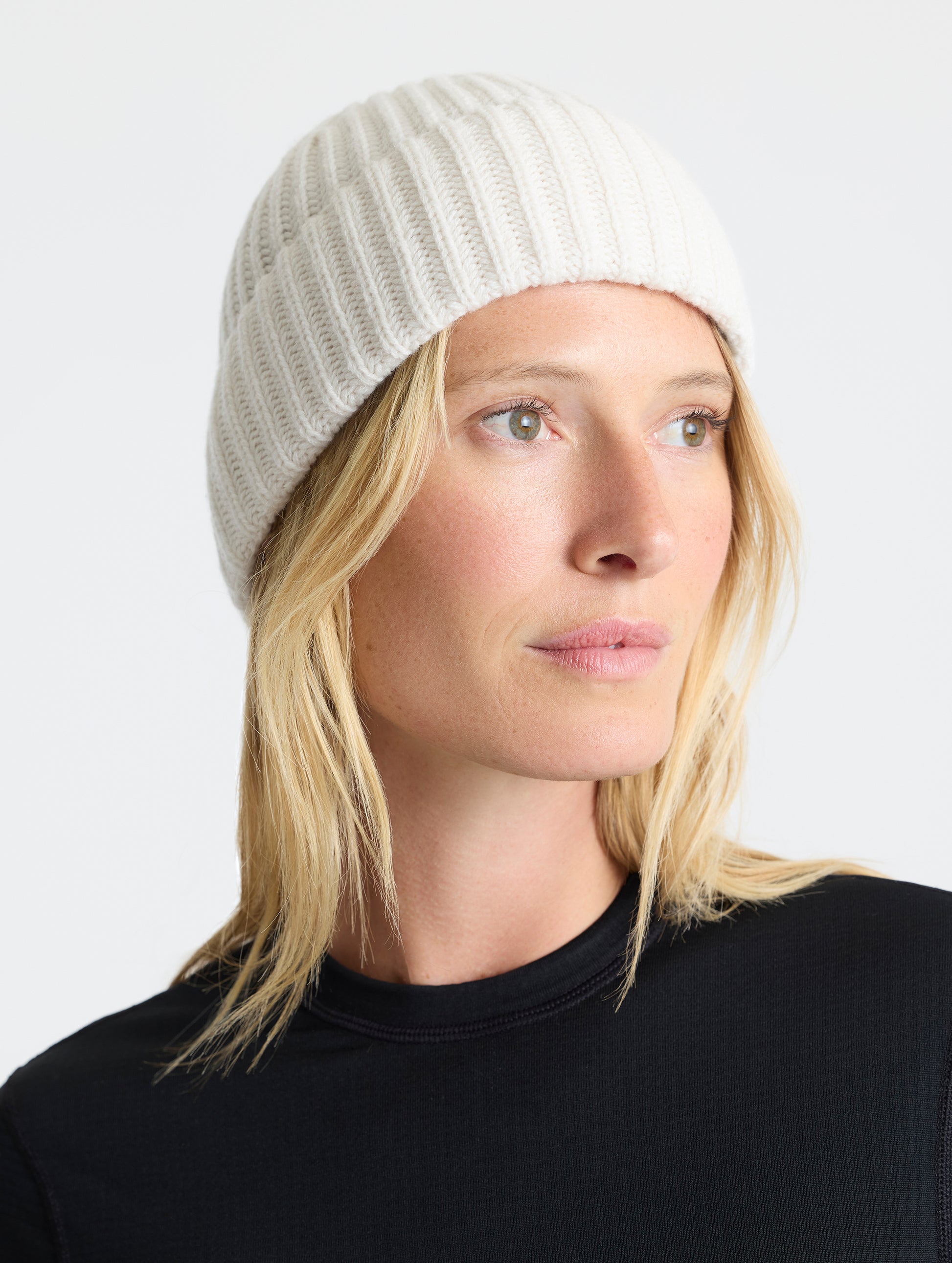 Front angled view of woman wearing the Cashmere Hat in Winter White from AETHER Apparel. 