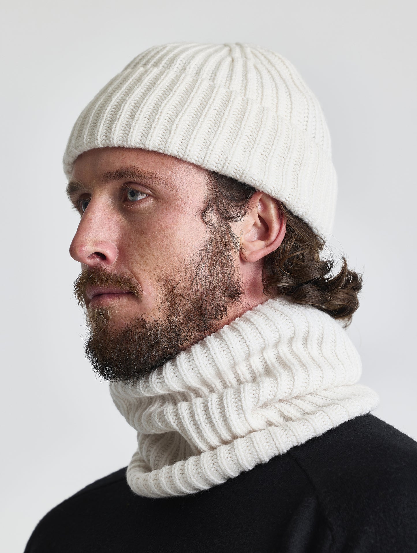 Front left angled view of man wearing the Cashmere Hat in Winter White from AETHER Apparel.