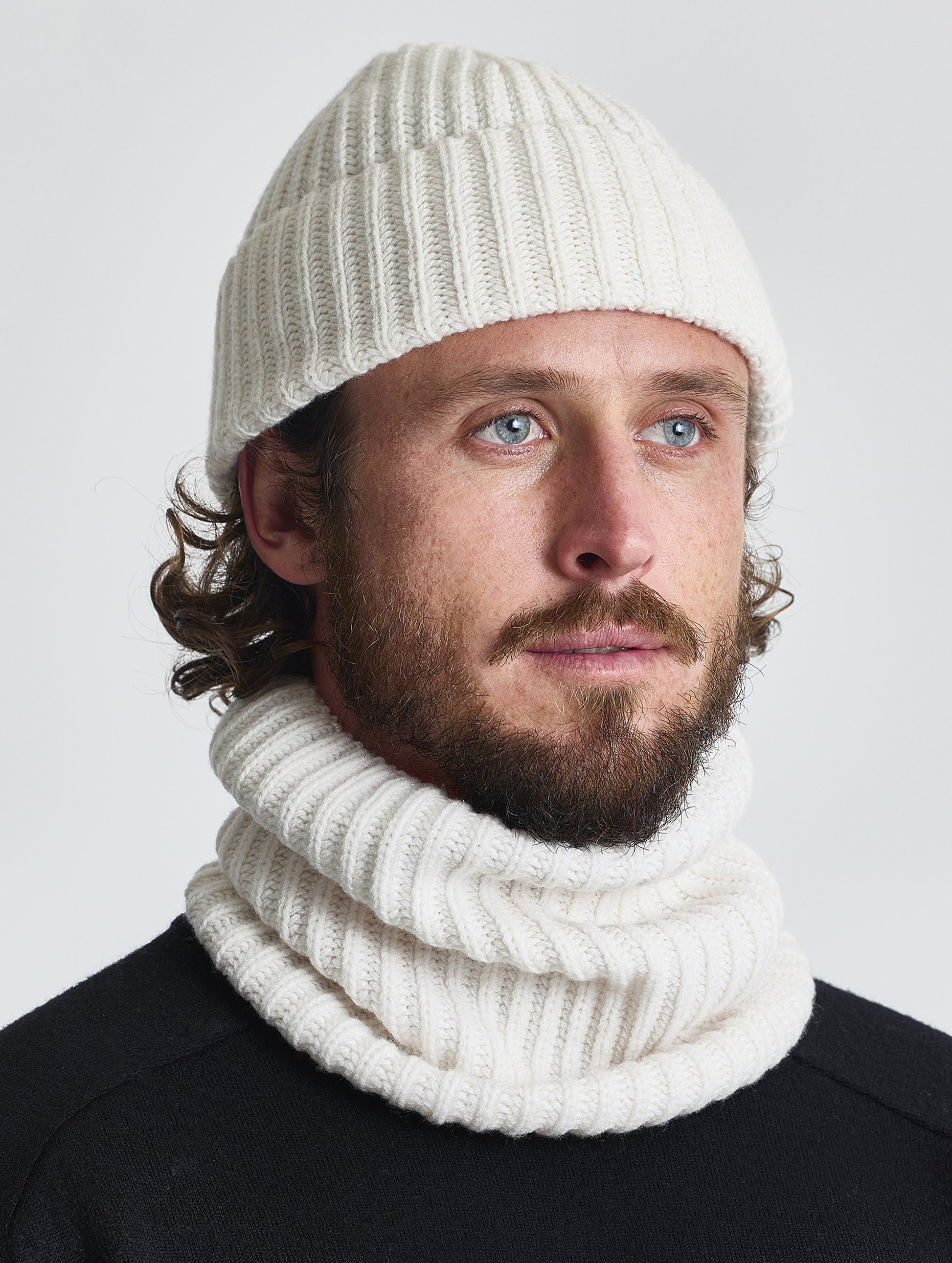 Front right angled view of man wearing the Cashmere Hat in Winter White from AETHER Apparel.