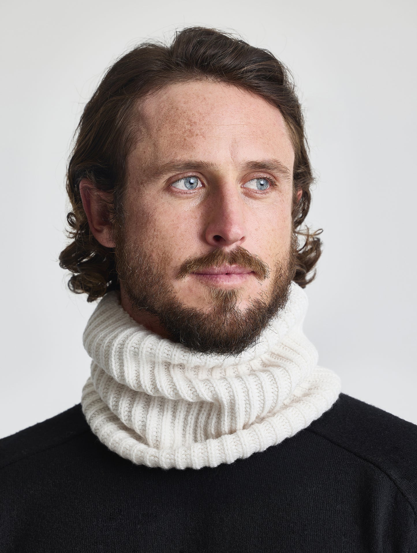 Front view of man wearing the Cashmere Neck Gaiter in Winter White from AETHER Apparel. 