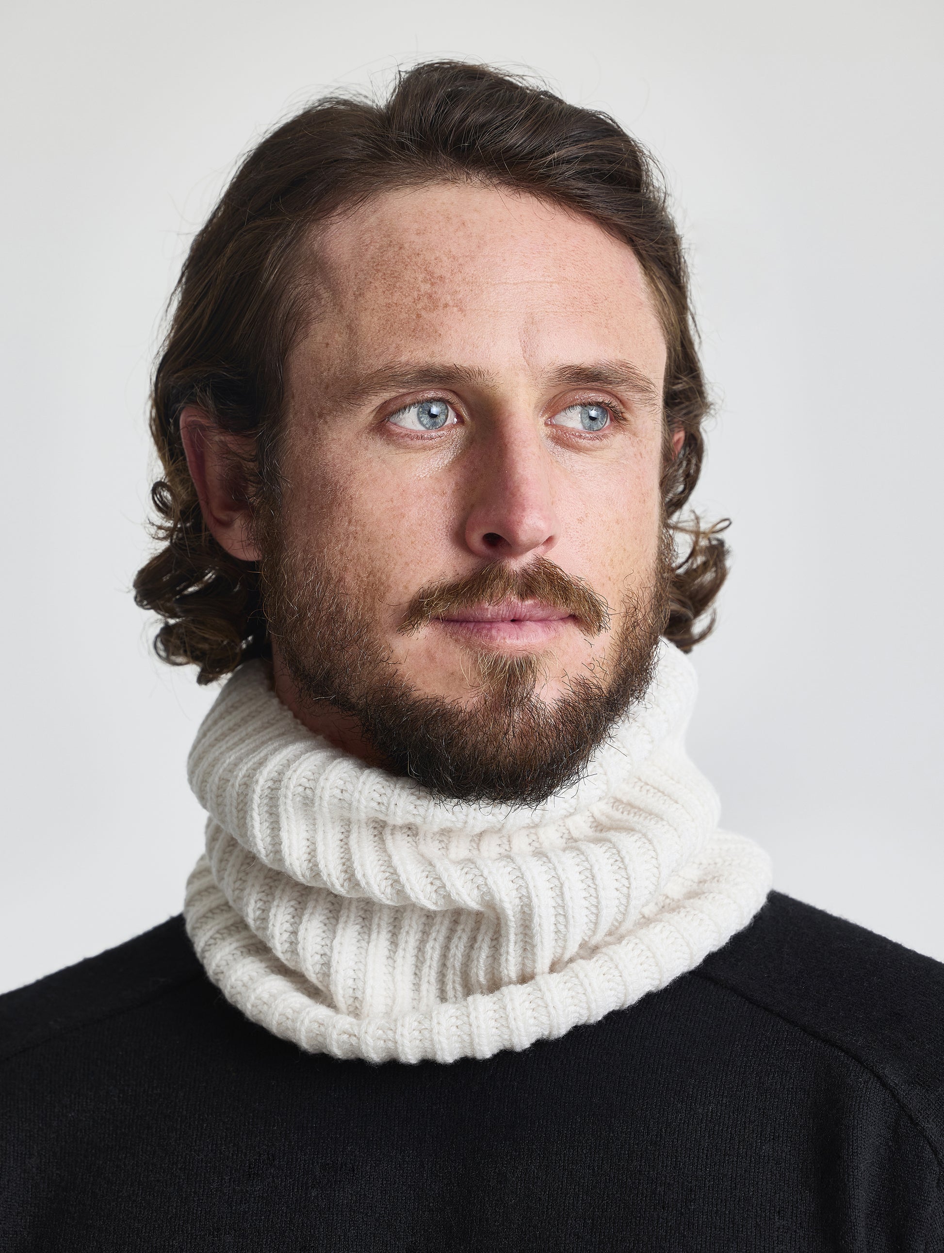 Front view of man wearing the Cashmere Neck Gaiter in Winter White from AETHER Apparel. 
