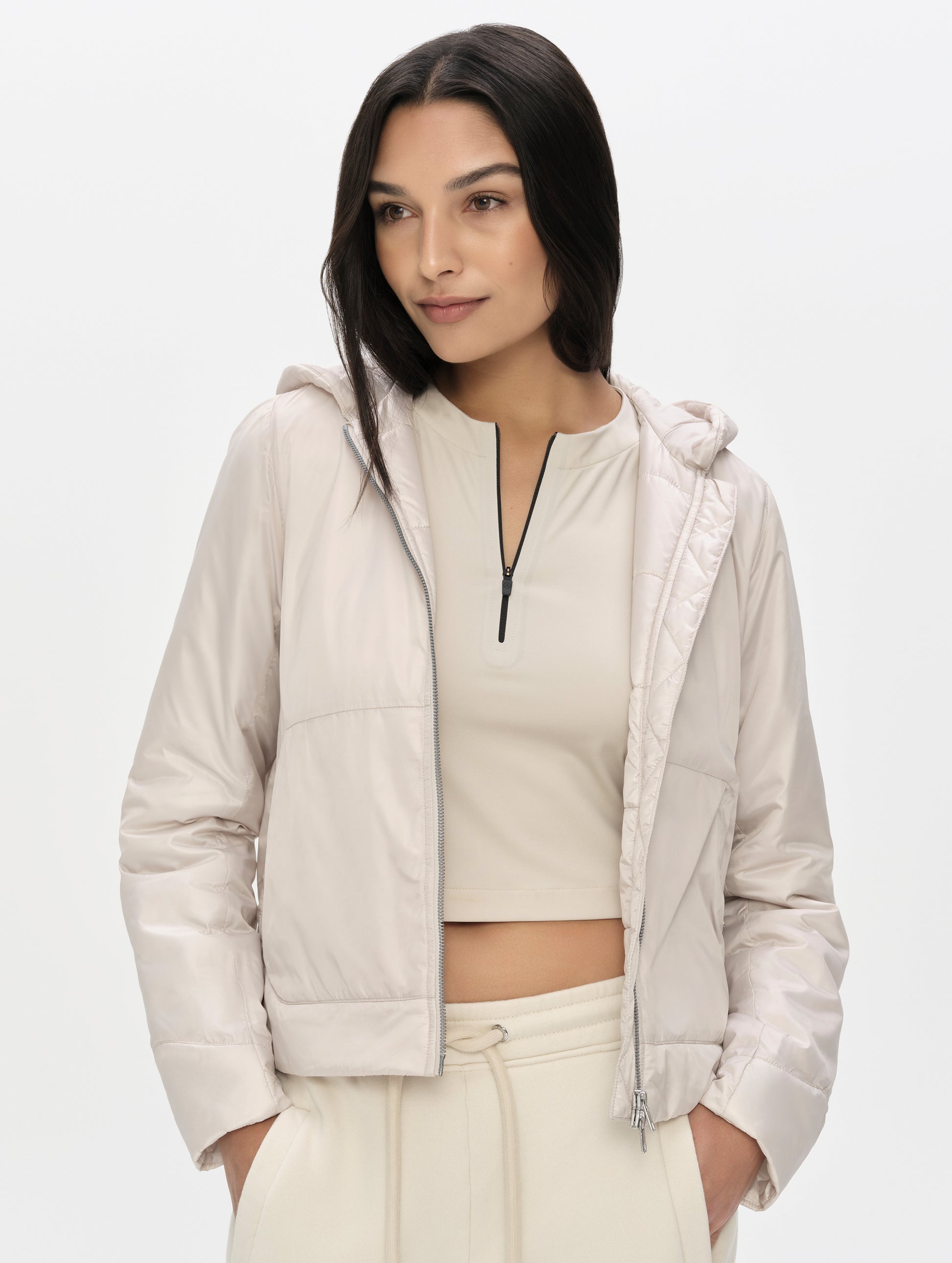Front upper-body view of woman wearing the Celeste Eco Insulated Vest in Bone from AETHER Apparel.
