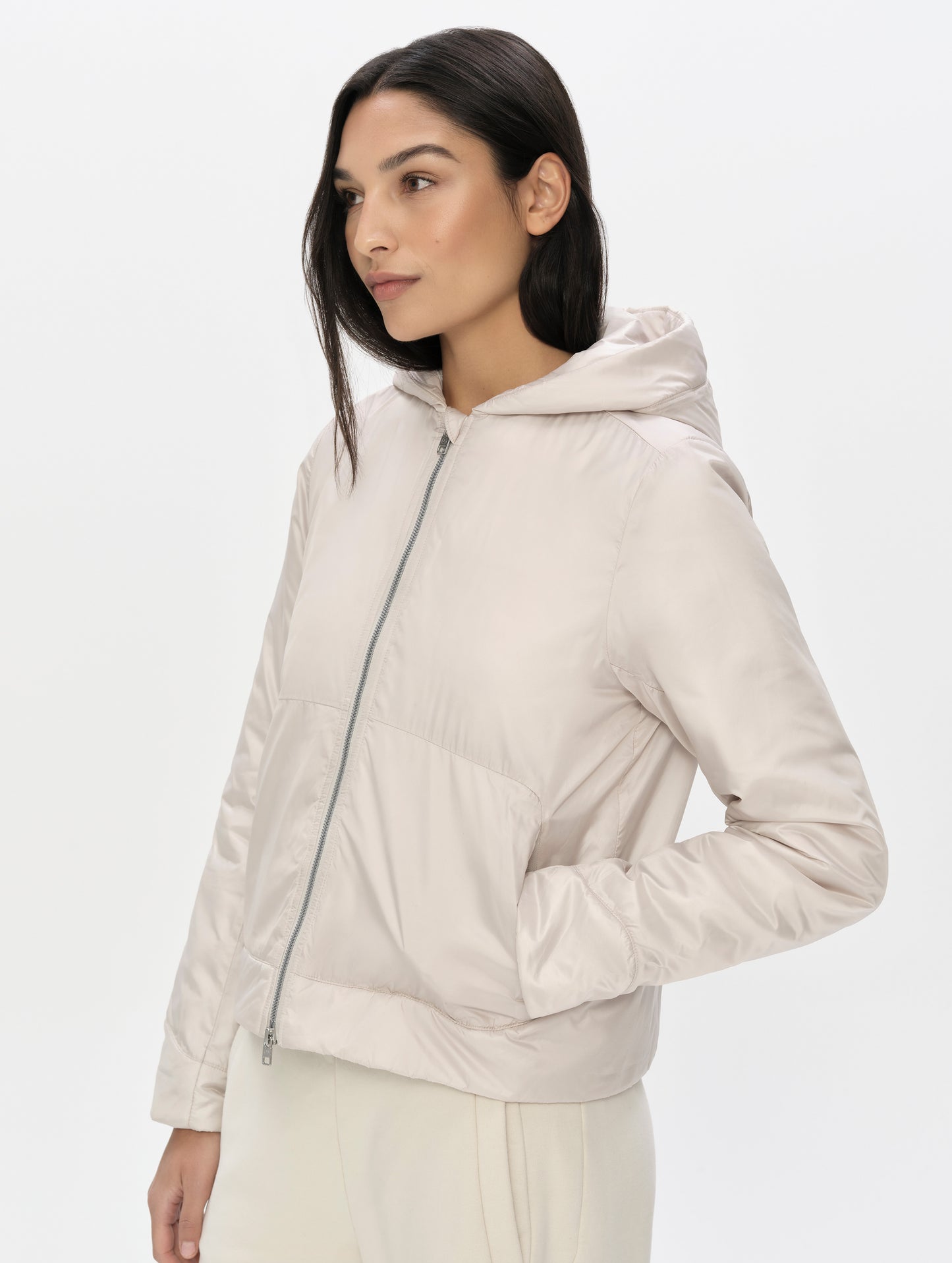 Front, angled upper-body view of woman wearing the Celeste Eco Insulated Vest in Bone from AETHER Apparel.