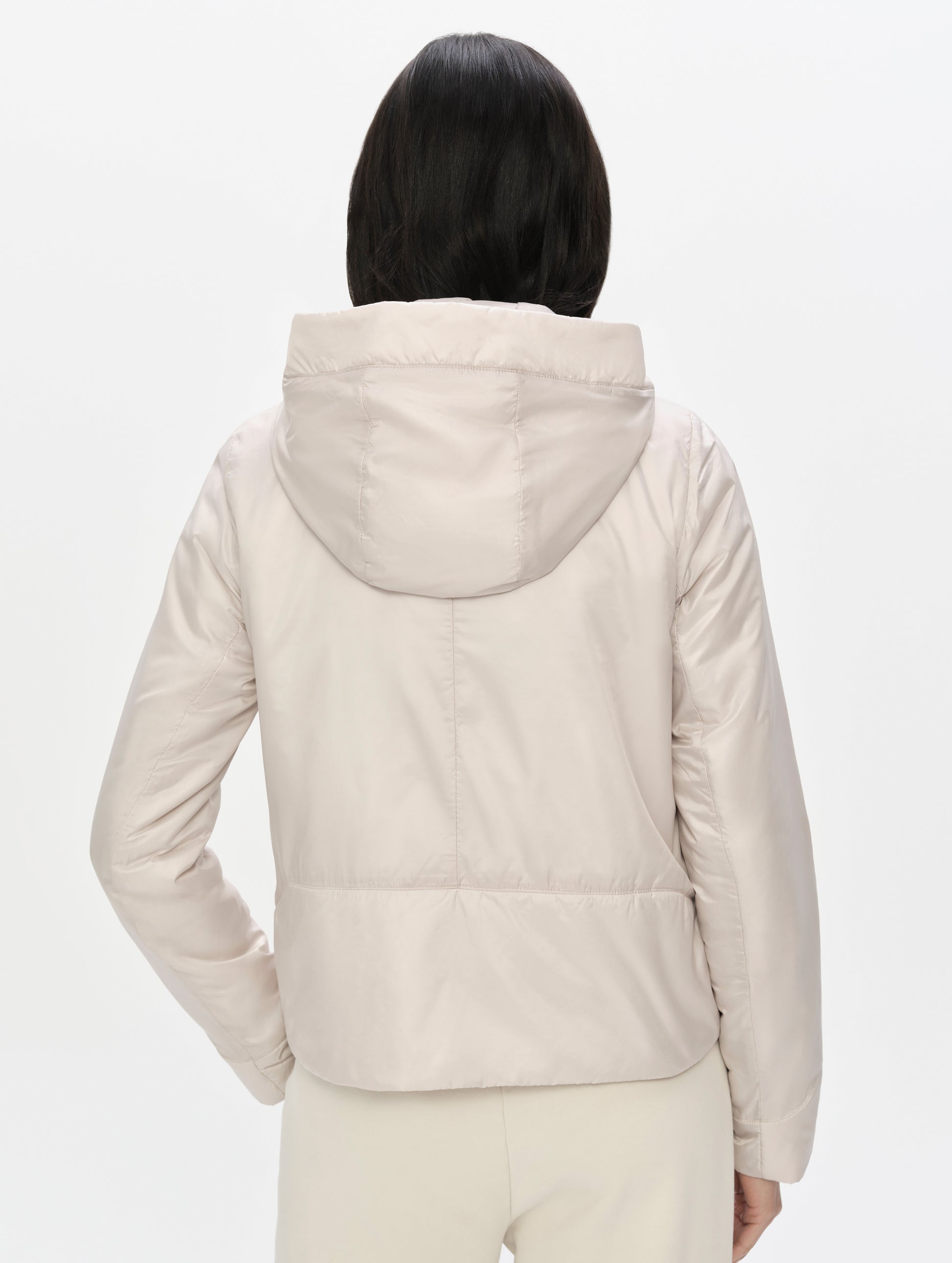 Rear upper-body view of woman wearing the Celeste Eco Insulated Vest in Bone from AETHER Apparel.