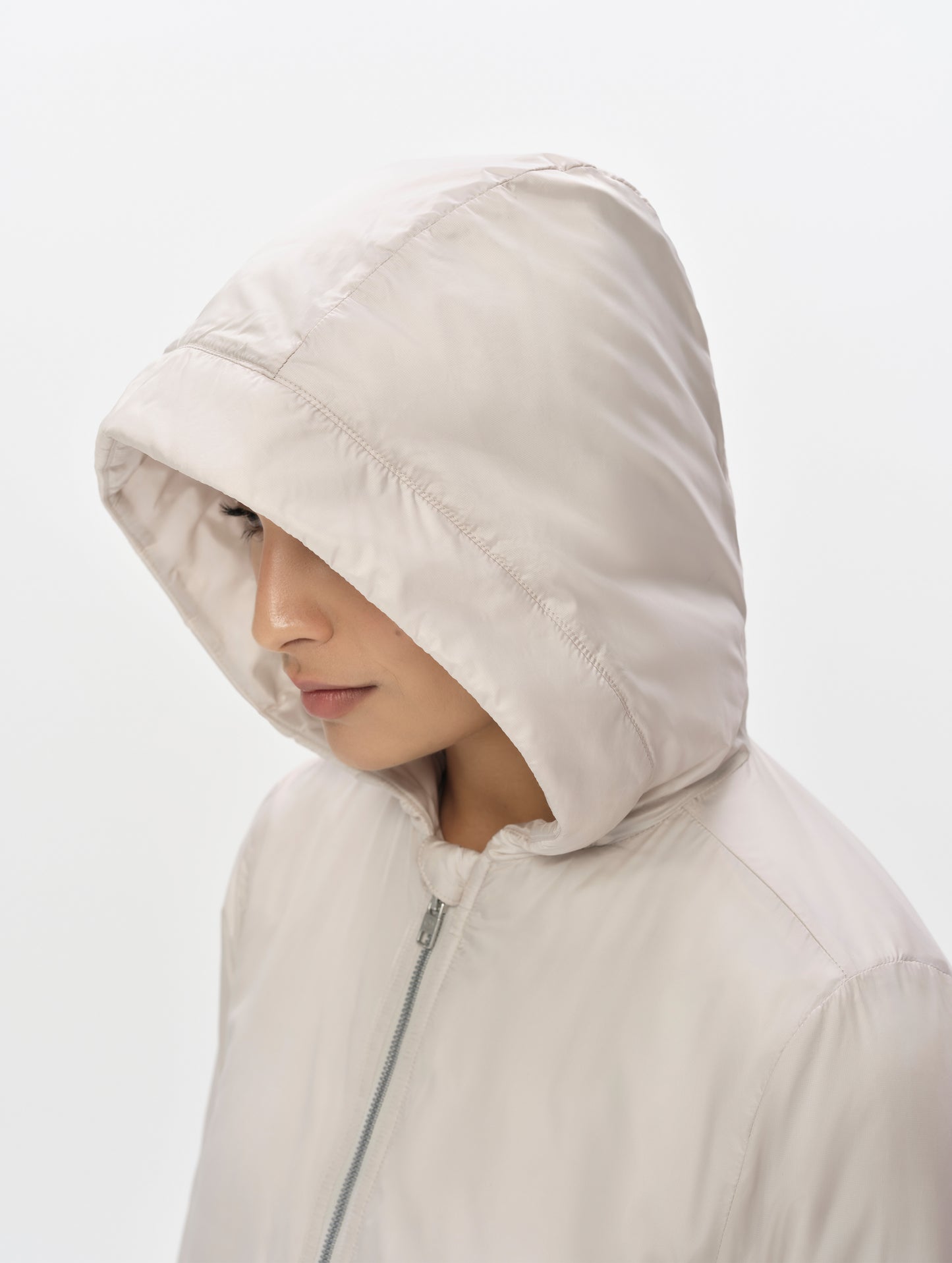 Closeup detailed view of the three-piece hood on the Celeste Eco Insulated Hoodie in Bone from AETHER Apparel.