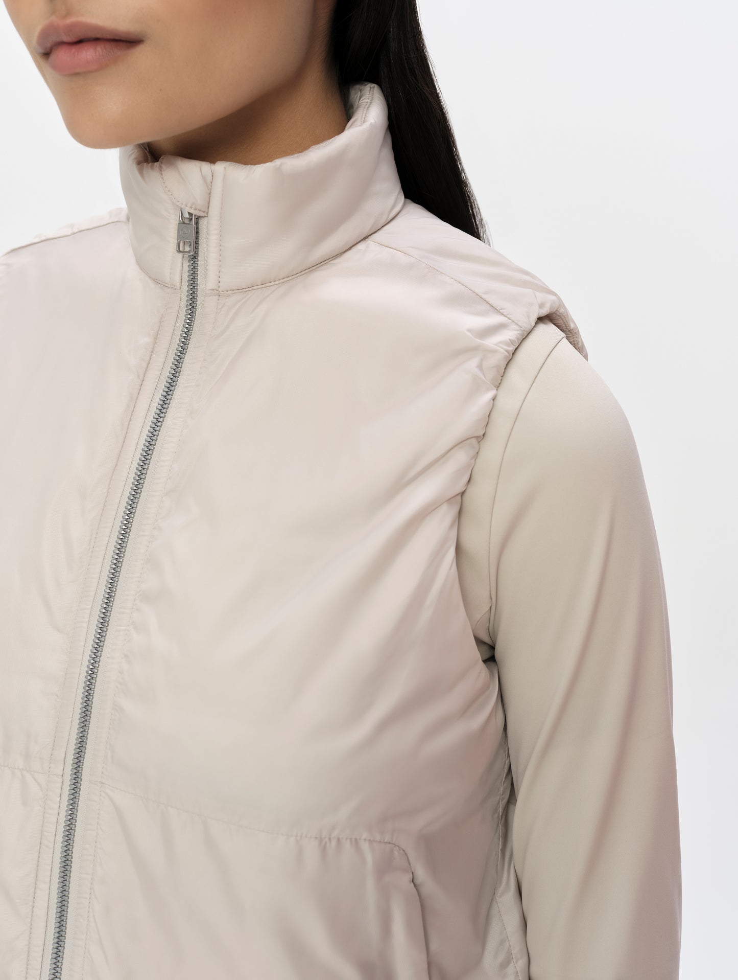 Closeup detailed view of the armhole and collar on the Celeste Eco Insulated Vest in Bone from AETHER Apparel.