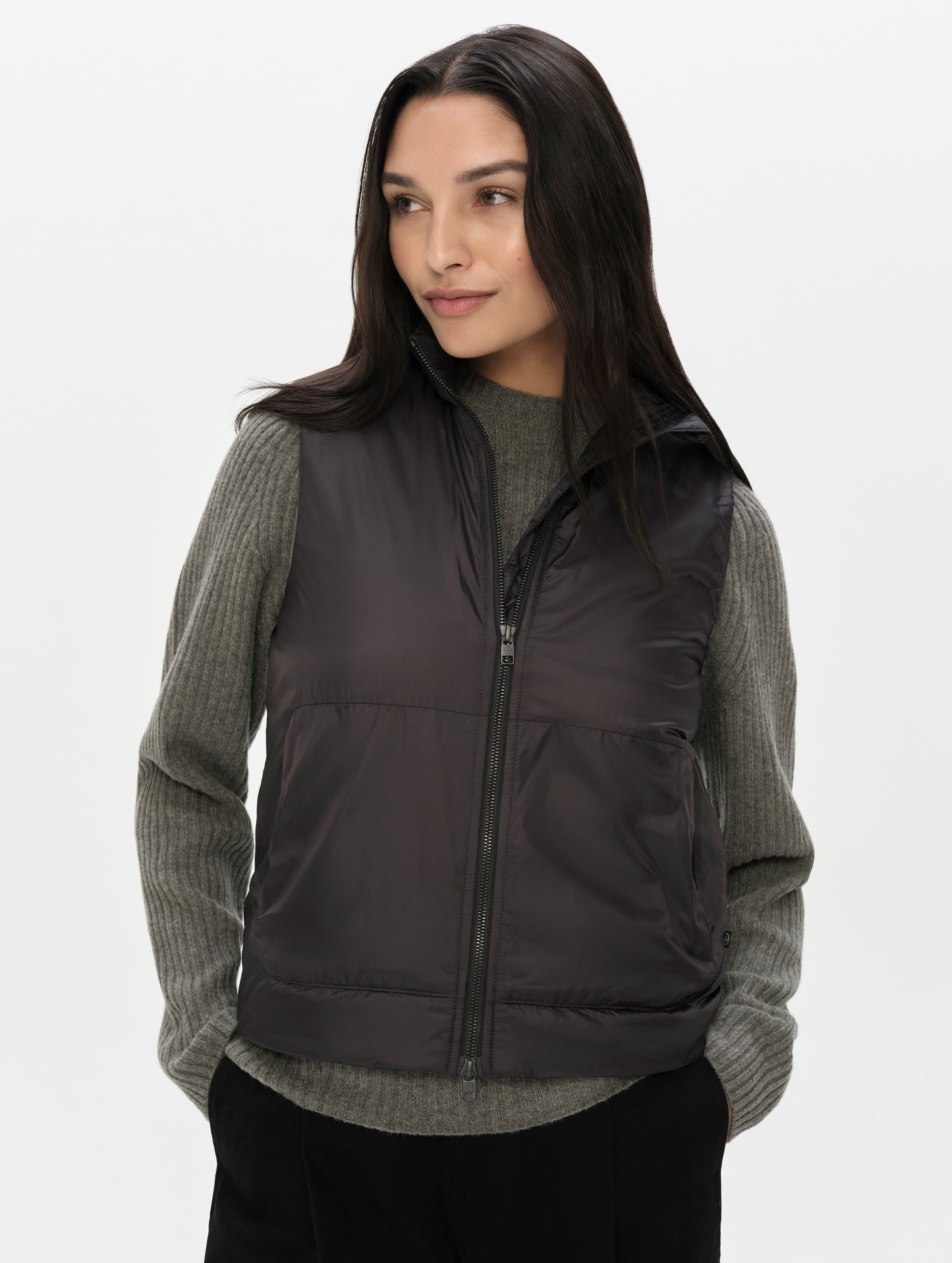 Front upper-body view of woman wearing the Celeste Eco Insulated Vest in Onyx Black from AETHER Apparel.