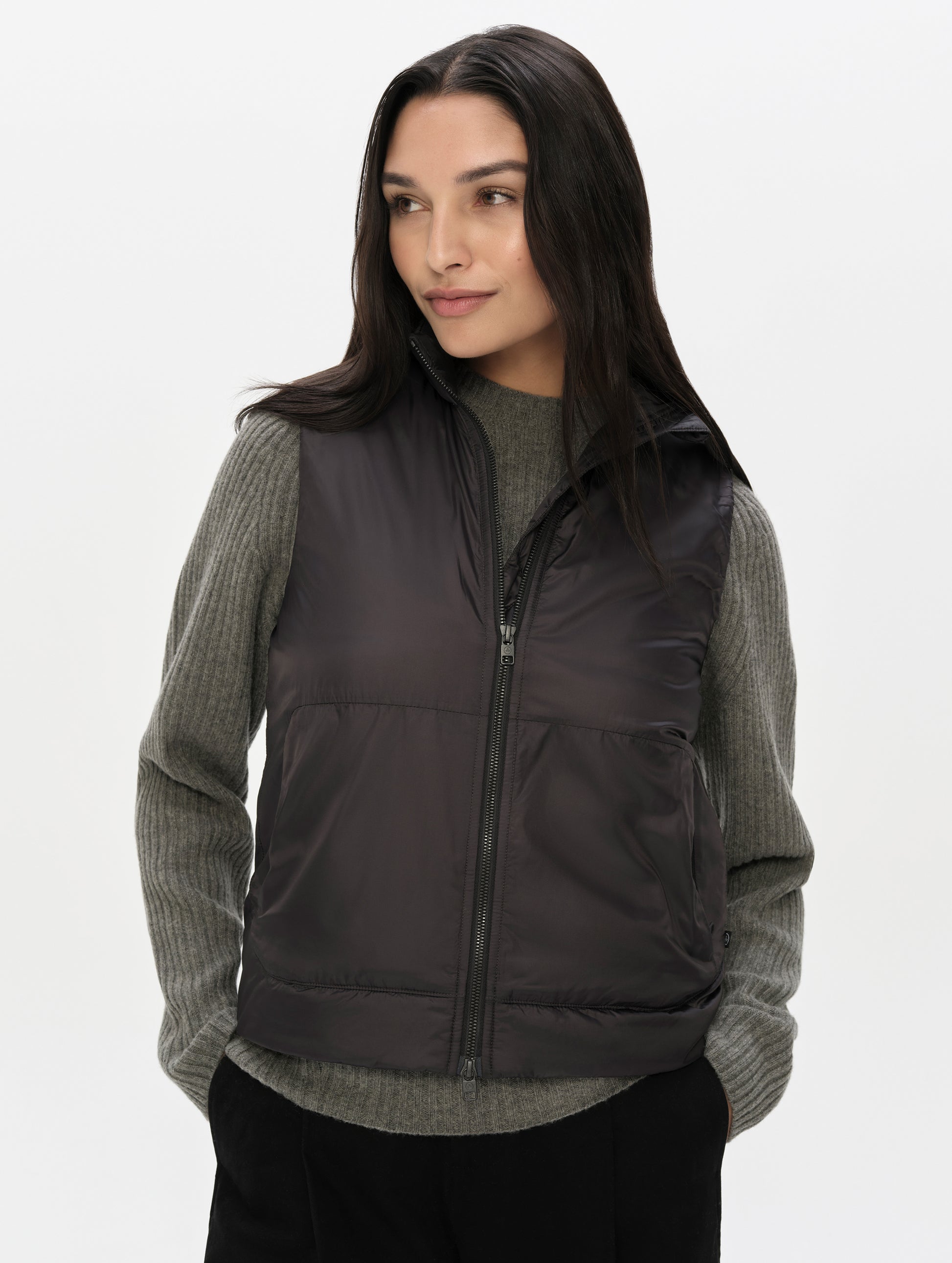 Front upper-body view of woman wearing the Celeste Eco Insulated Vest in Onyx Black from AETHER Apparel.