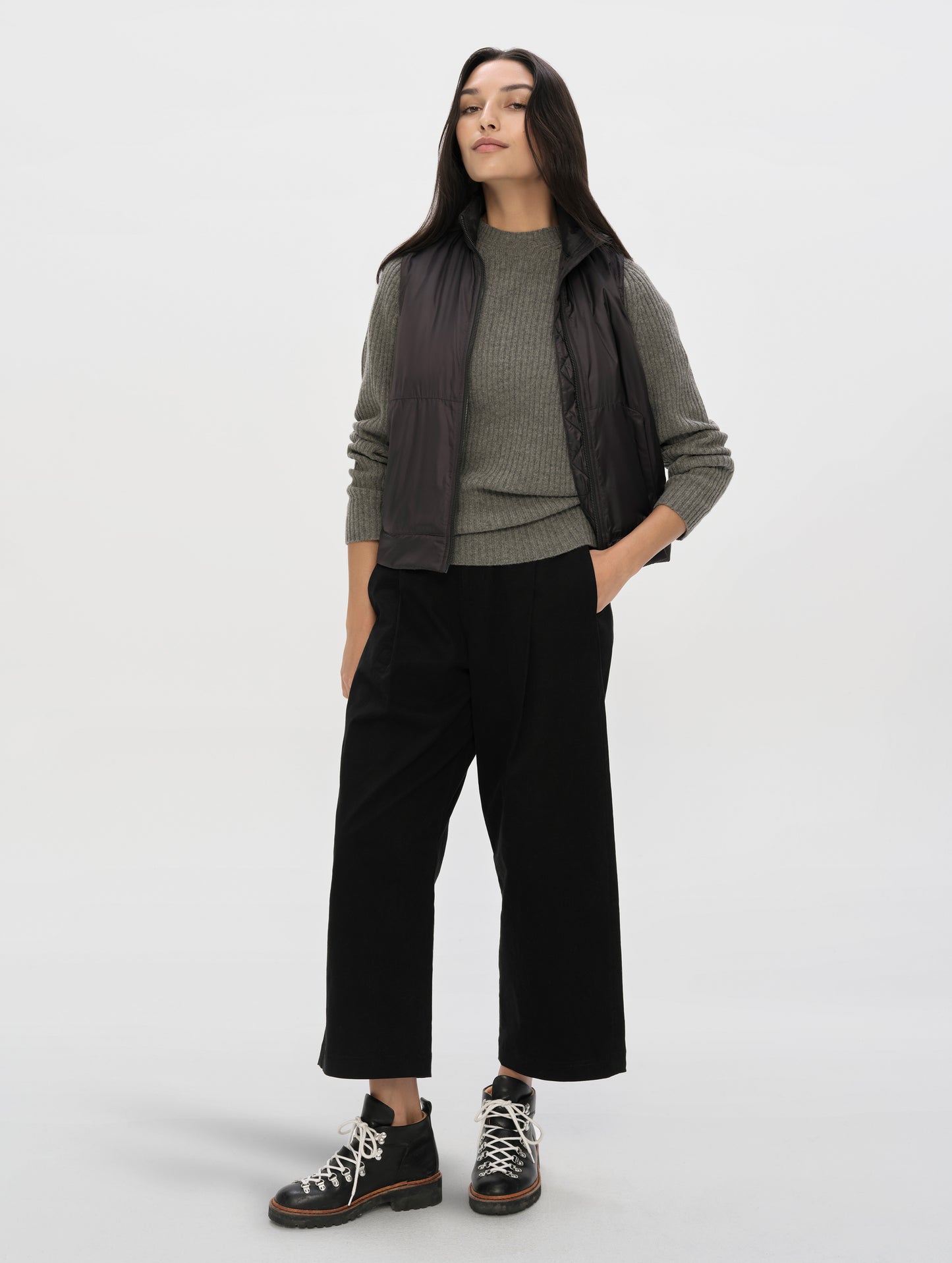 Front full-body view of woman wearing the Celeste Eco Insulated Vest in Onyx Black from AETHER Apparel.