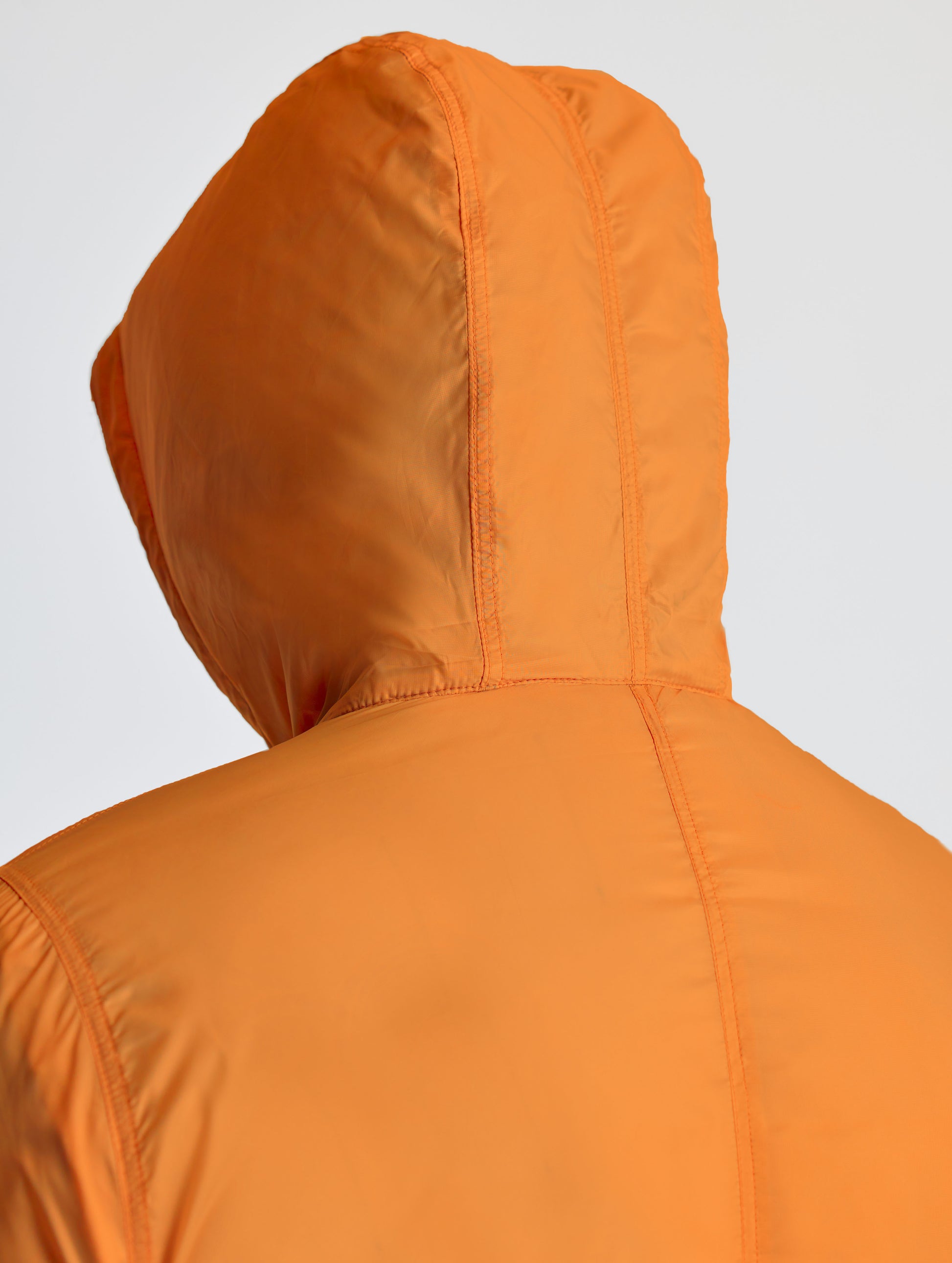 Closeup rear view of hood of Eco Space Hoodie in Autumn Orange from AETHER Apparel.