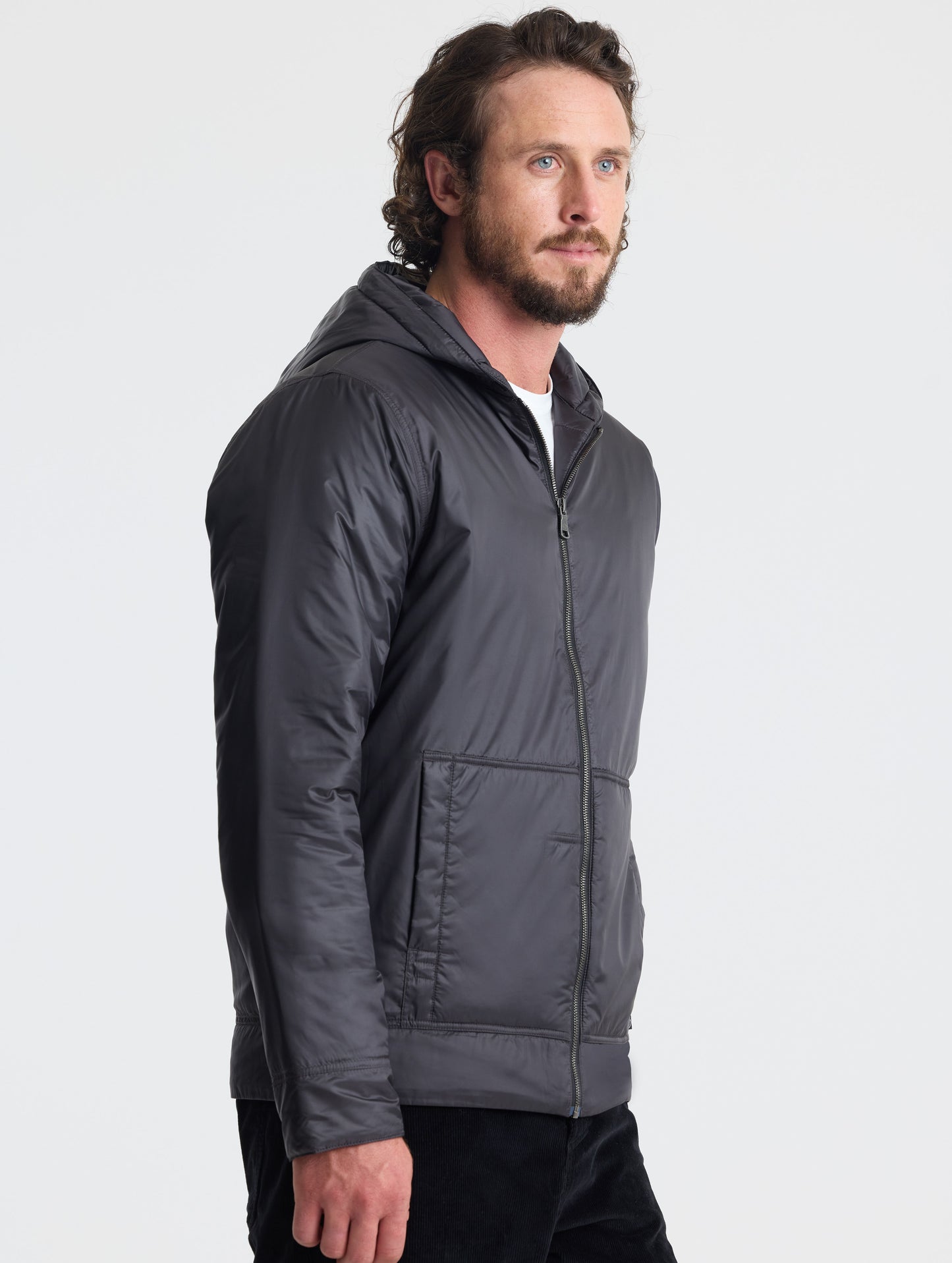 Angled view of man wearing Eco Space Hoodie in Onyx Black from AETHER Apparel.