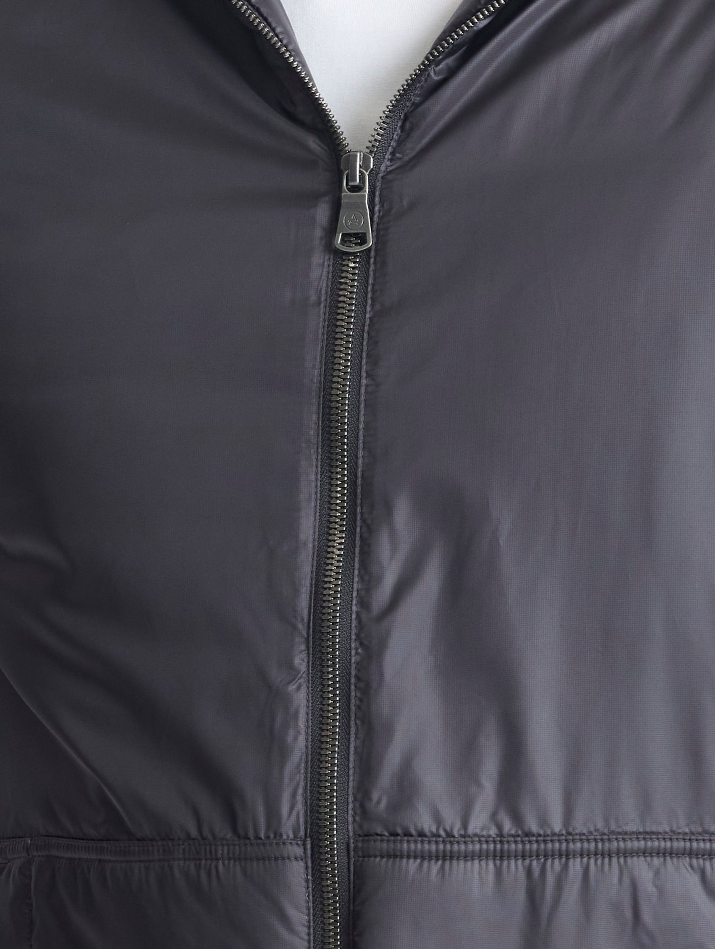Closeup view of center zipper of Eco Space Hoodie in Onyx Black from AETHER Apparel.
