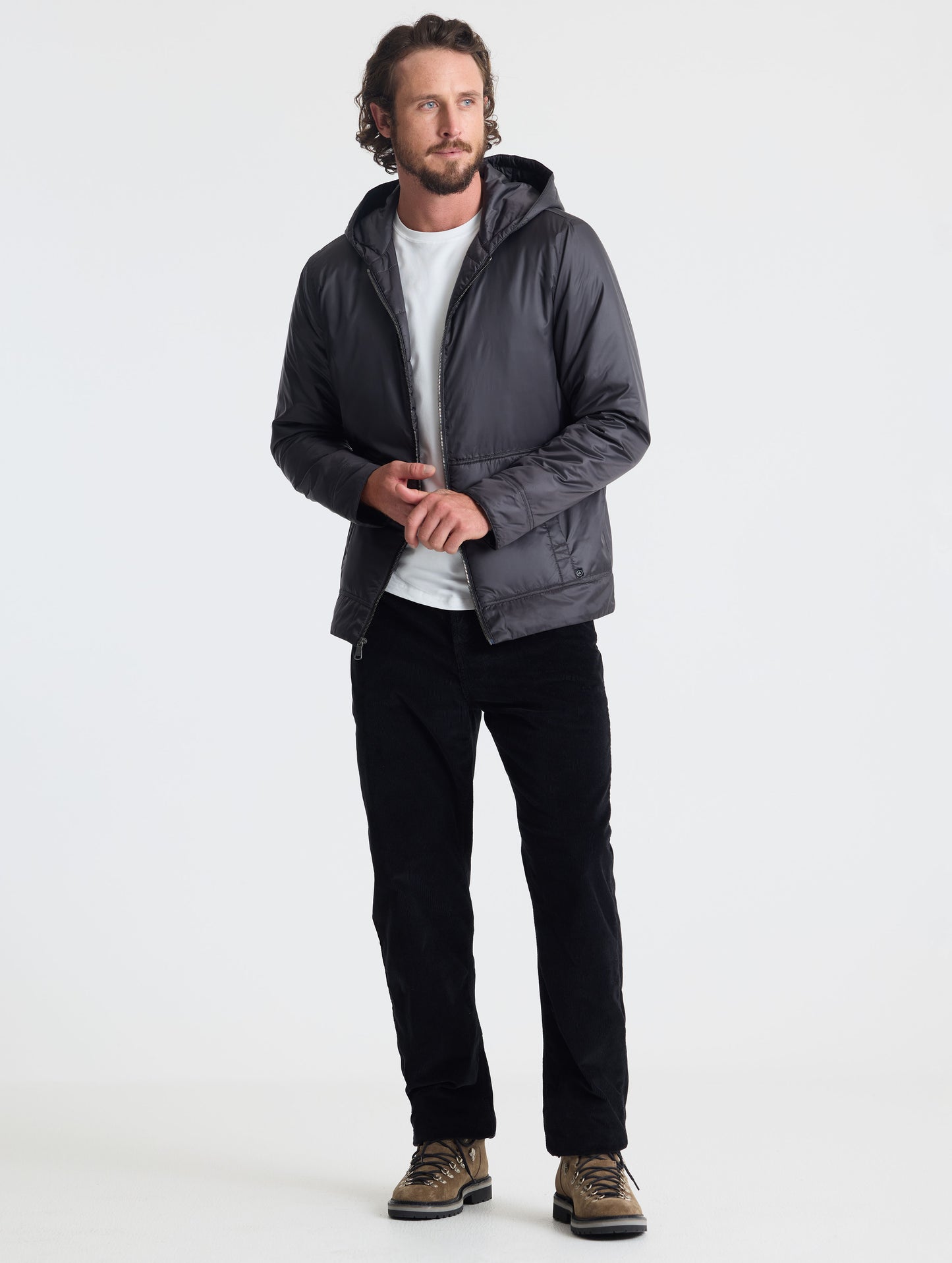 Full body view of man wearing Eco Space Hoodie in Onyx Black from AETHER Apparel.