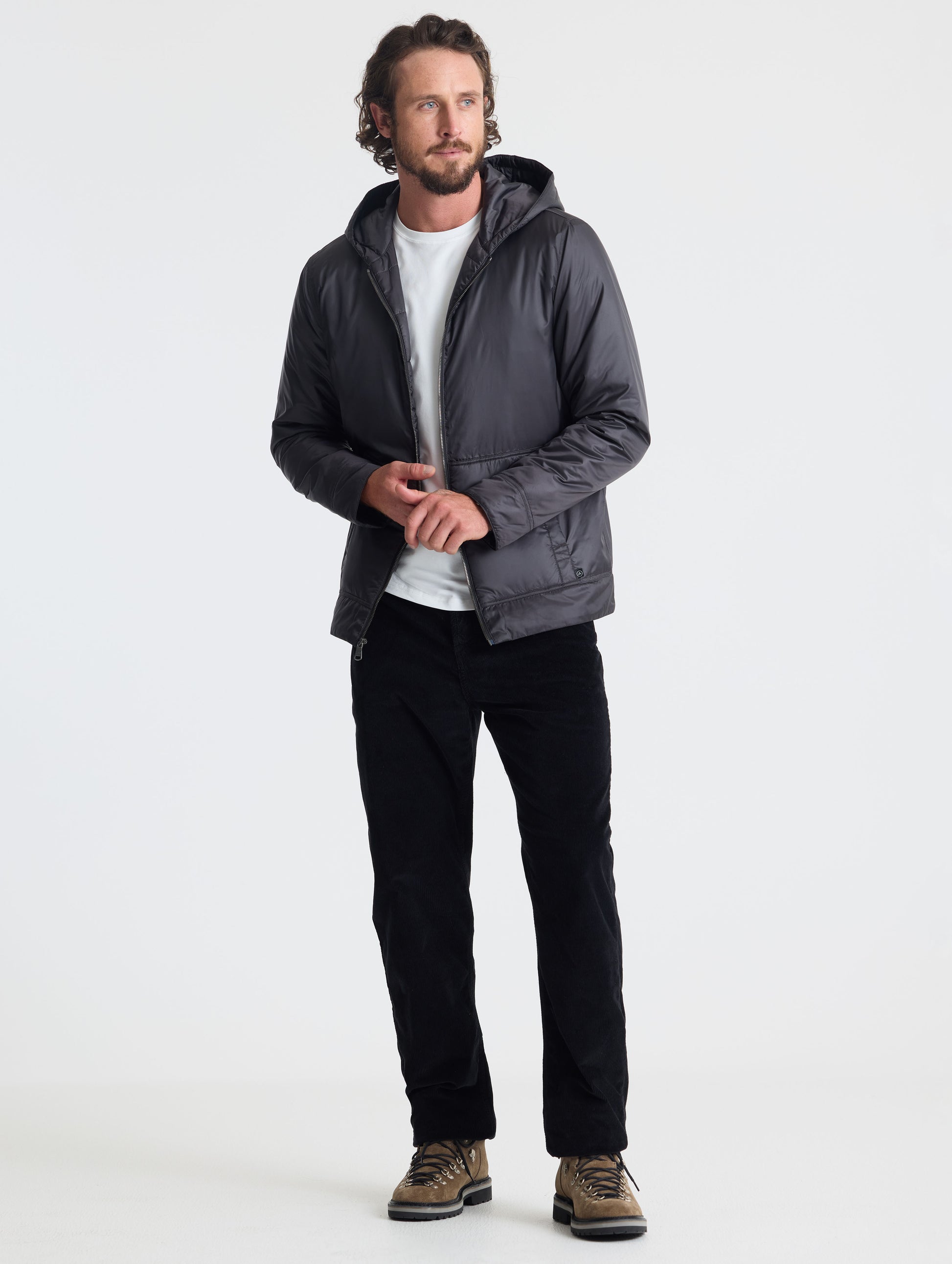 Full body view of man wearing Eco Space Hoodie in Onyx Black from AETHER Apparel.
