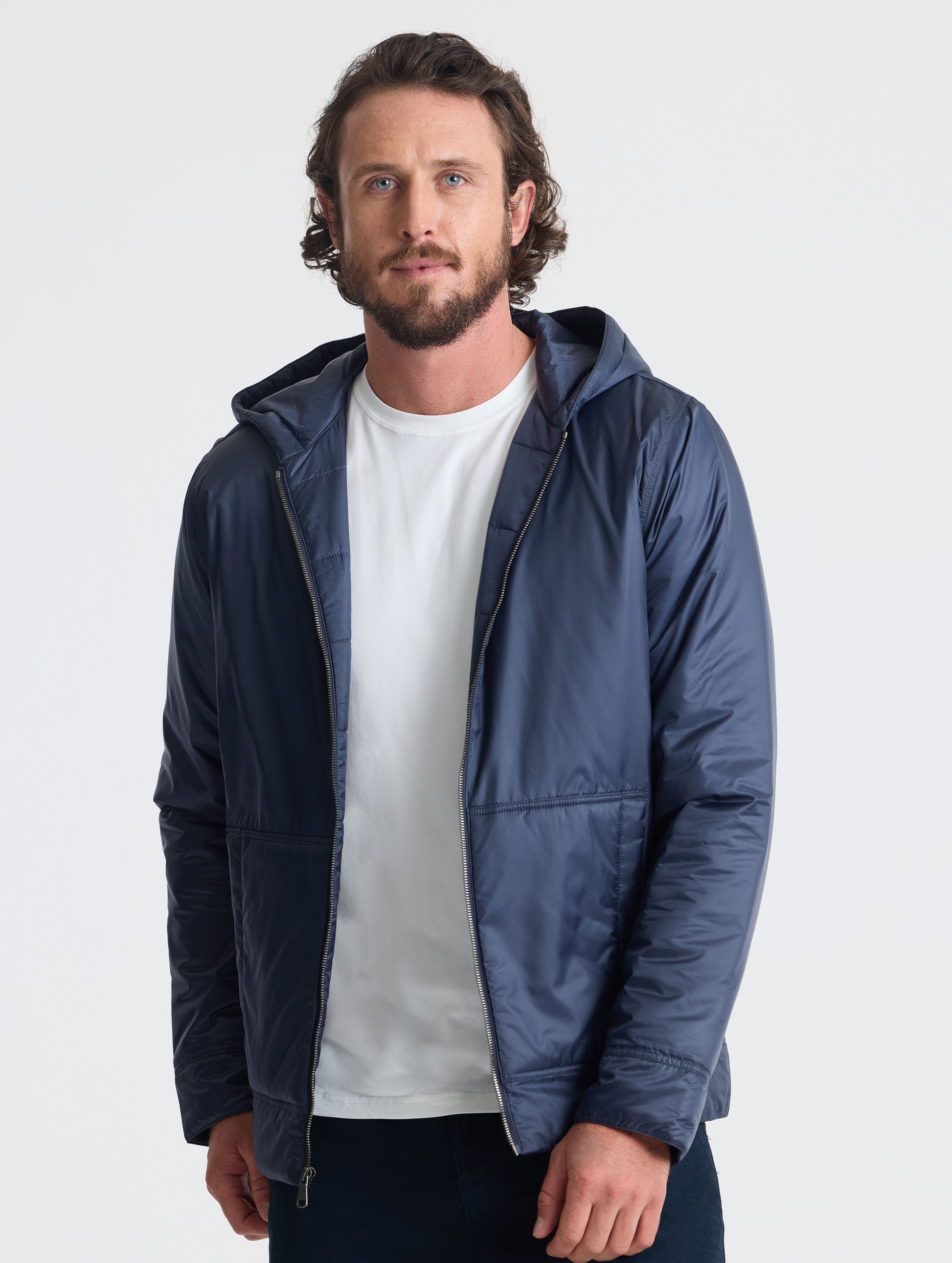 Front view of man wearing unzipped Eco Space Hoodie in Total Eclipse dark blue from AETHER Apparel.