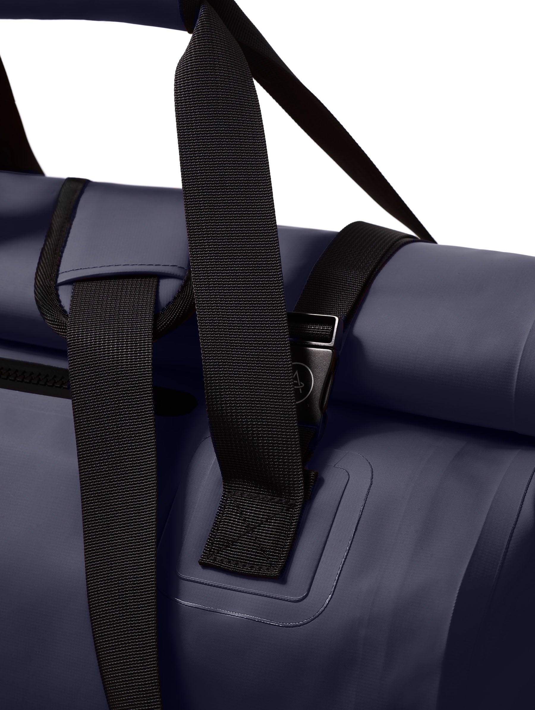 Closeup detailed view of the padded grab handle and padded shoulder strap on the Excursion Duffle Bag 60L in Total Eclipse dark blue from AETHER Apparel.