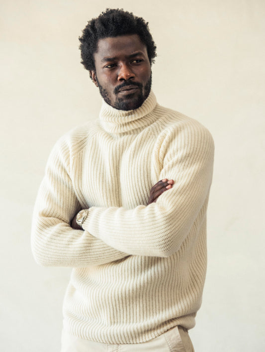 Front angled view of man with arms crossed wearing Finley Sweater in Winter White from AETHER Apparel.