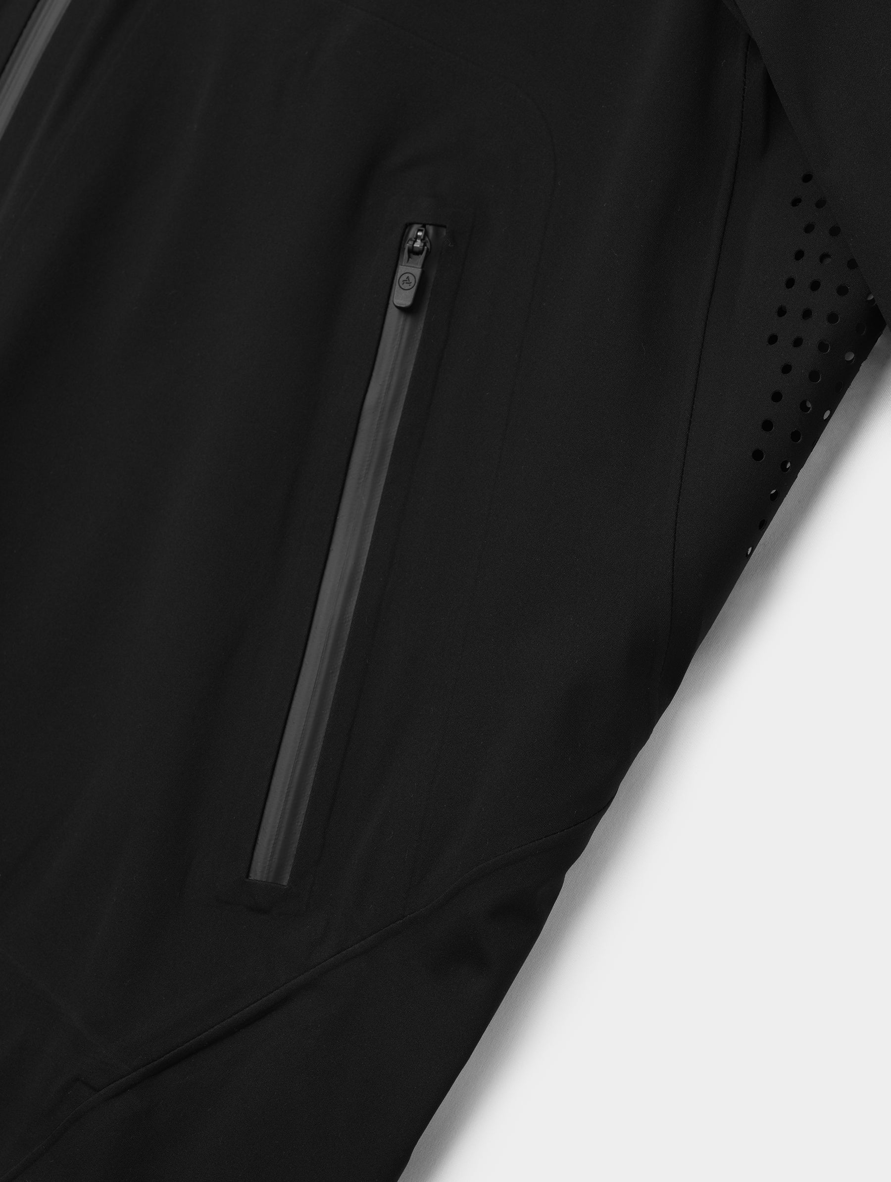 Closeup detailed view of one of the zipper-secured hand pockets on the Frontier Pant in Onyx Black from AETHER Apparel.