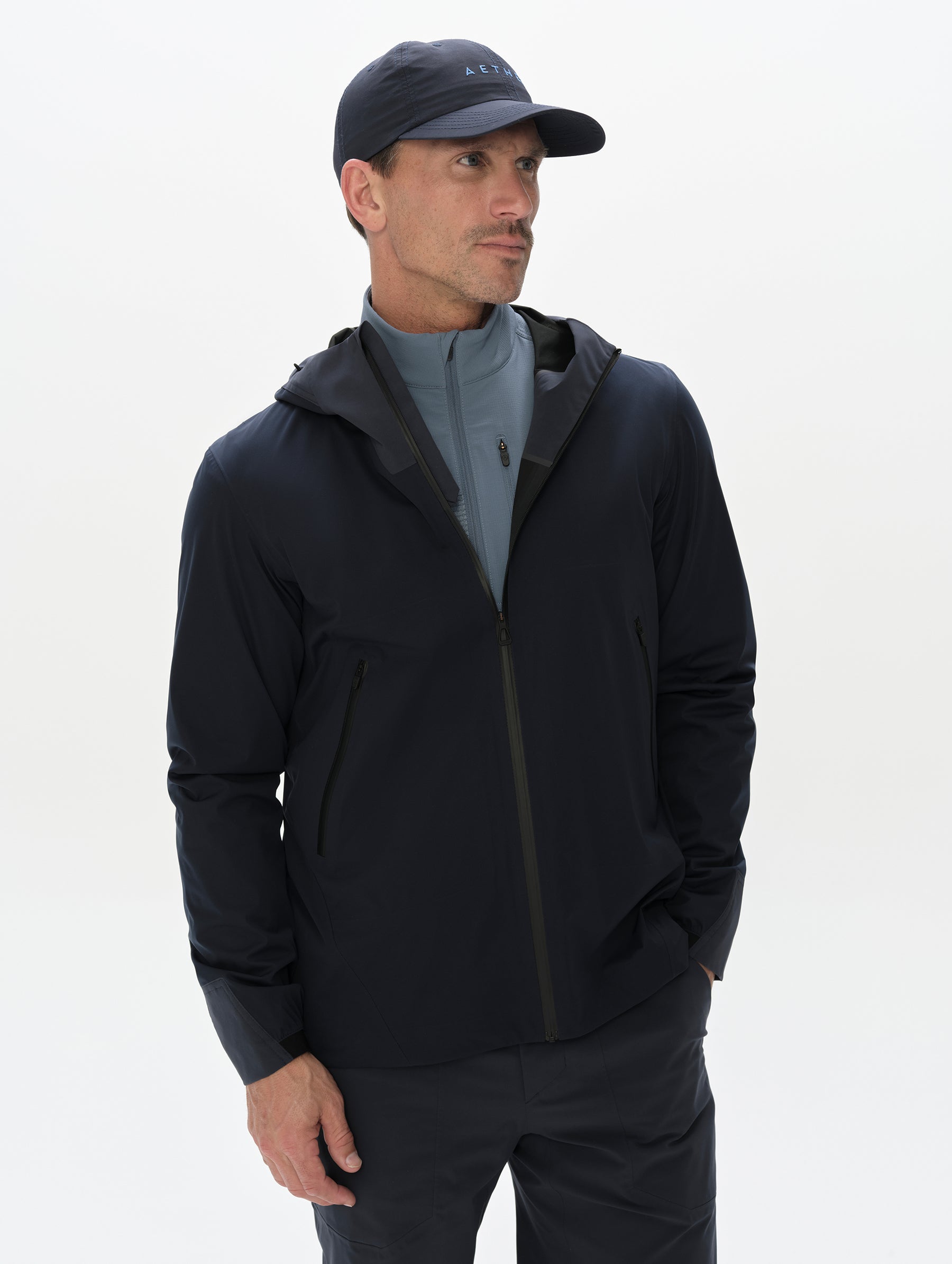 Front, upper-body view of man wearing the Frontier Pant in Total Eclipse dark blue from AETHER Apparel.
