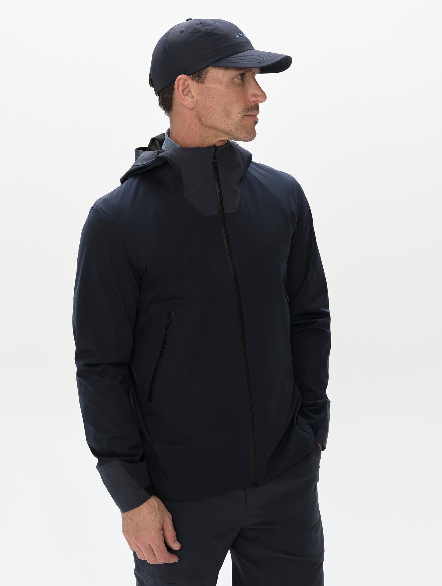 Front, 3/4, upper-body view of man wearing the Frontier Pant in Total Eclipse dark blue from AETHER Apparel.
