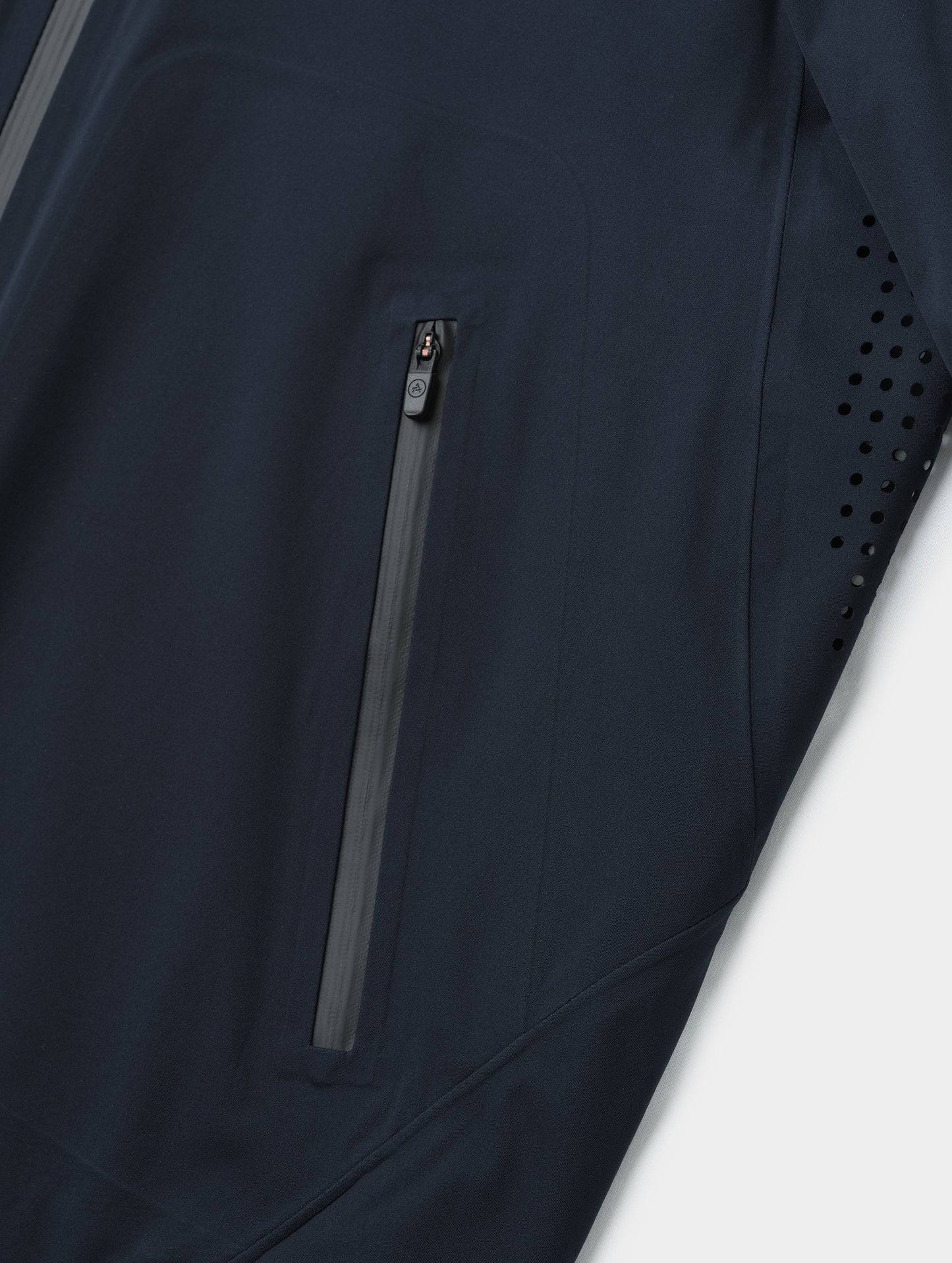 Closeup detailed view of one of the zipper-secured hand pockets on the Frontier Pant in Total Eclipse dark blue from AETHER Apparel.