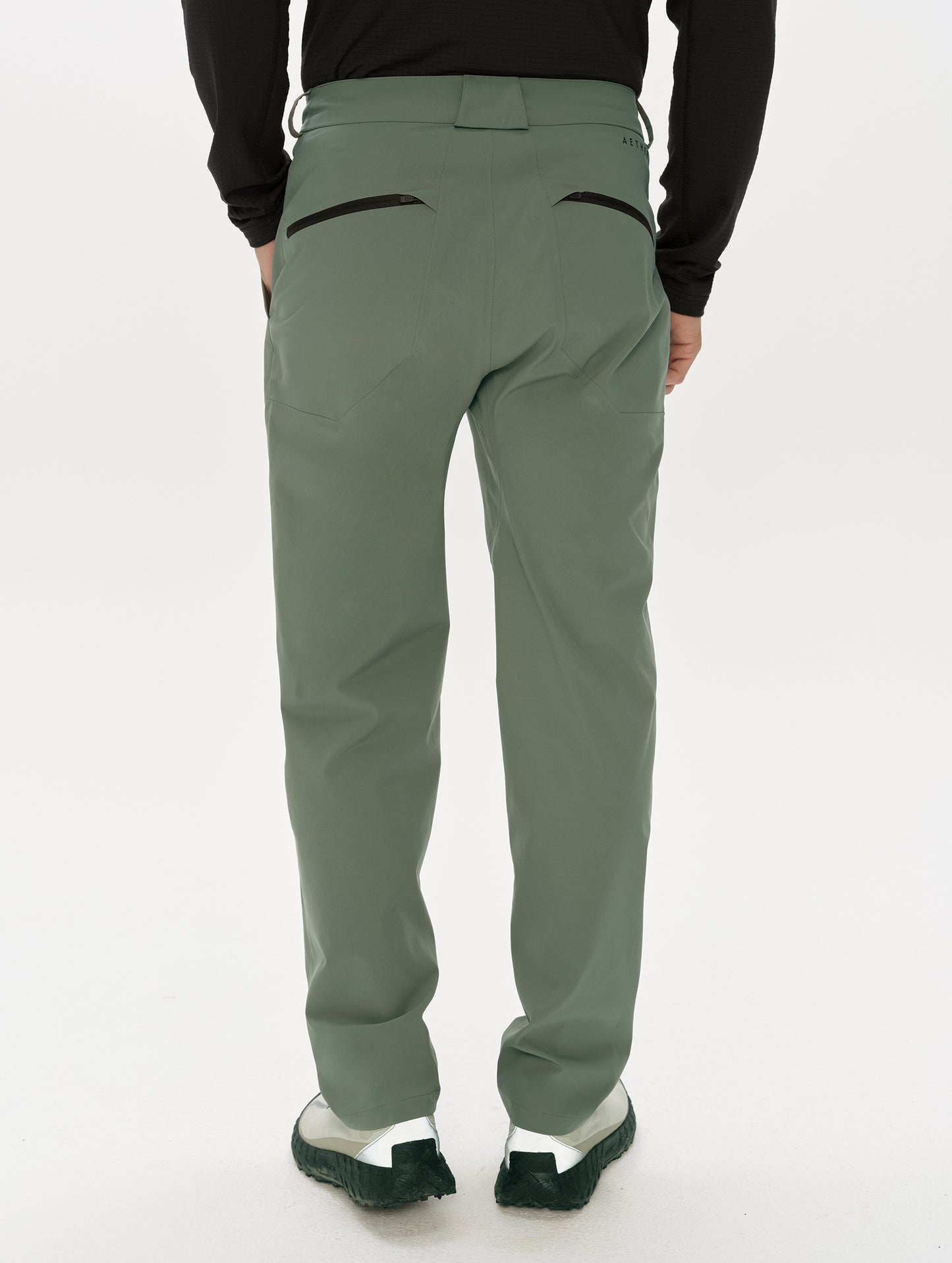 Rear, lower-body view of man wearing the Frontier Pant in Gunmetal  from AETHER Apparel.