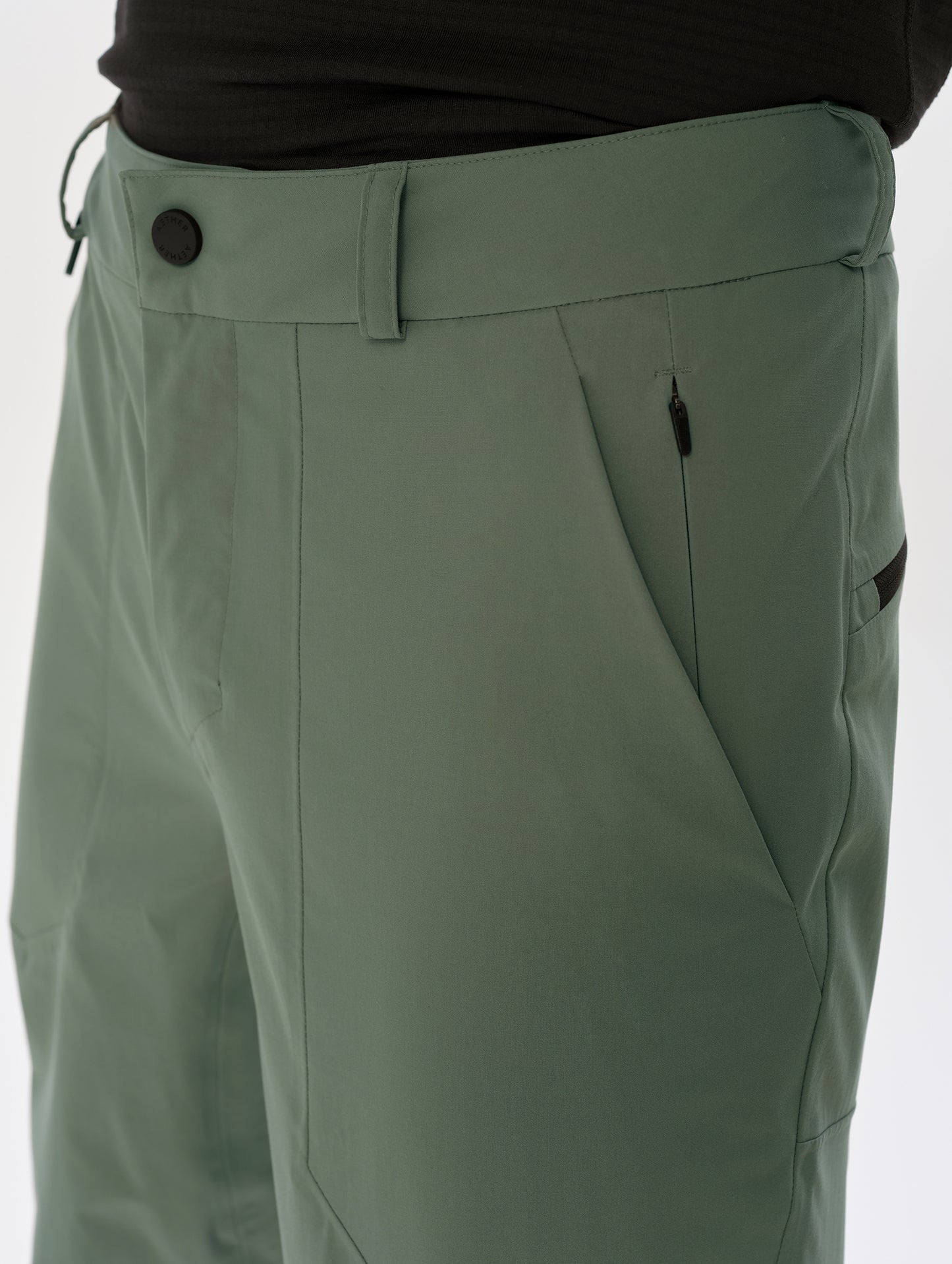 Closeup detailed view of the front closure and left hand pocket on the Frontier Pant in Gunmetal  from AETHER Apparel.
