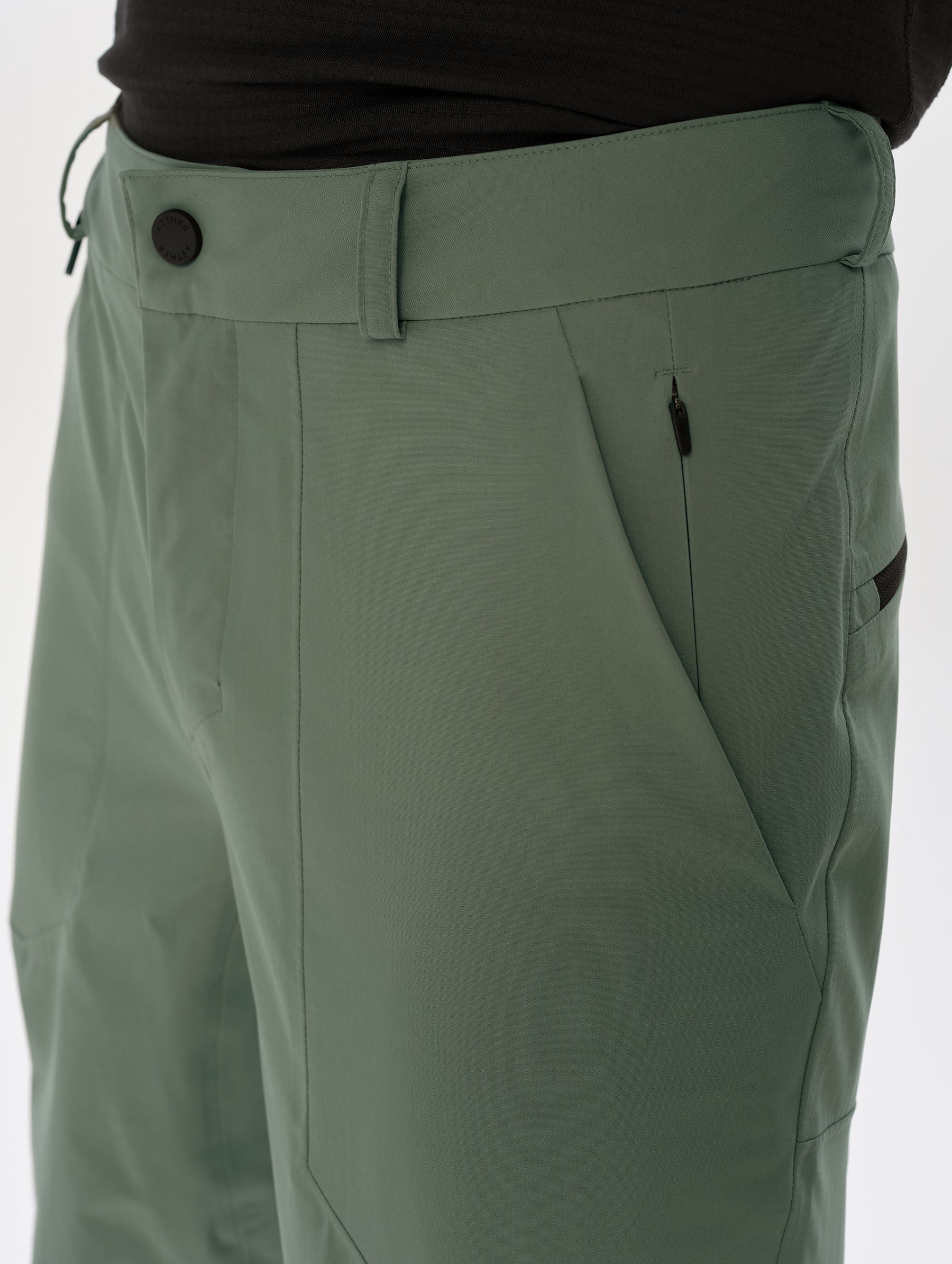 Closeup detailed view of the front closure and left hand pocket on the Frontier Pant in Gunmetal  from AETHER Apparel.