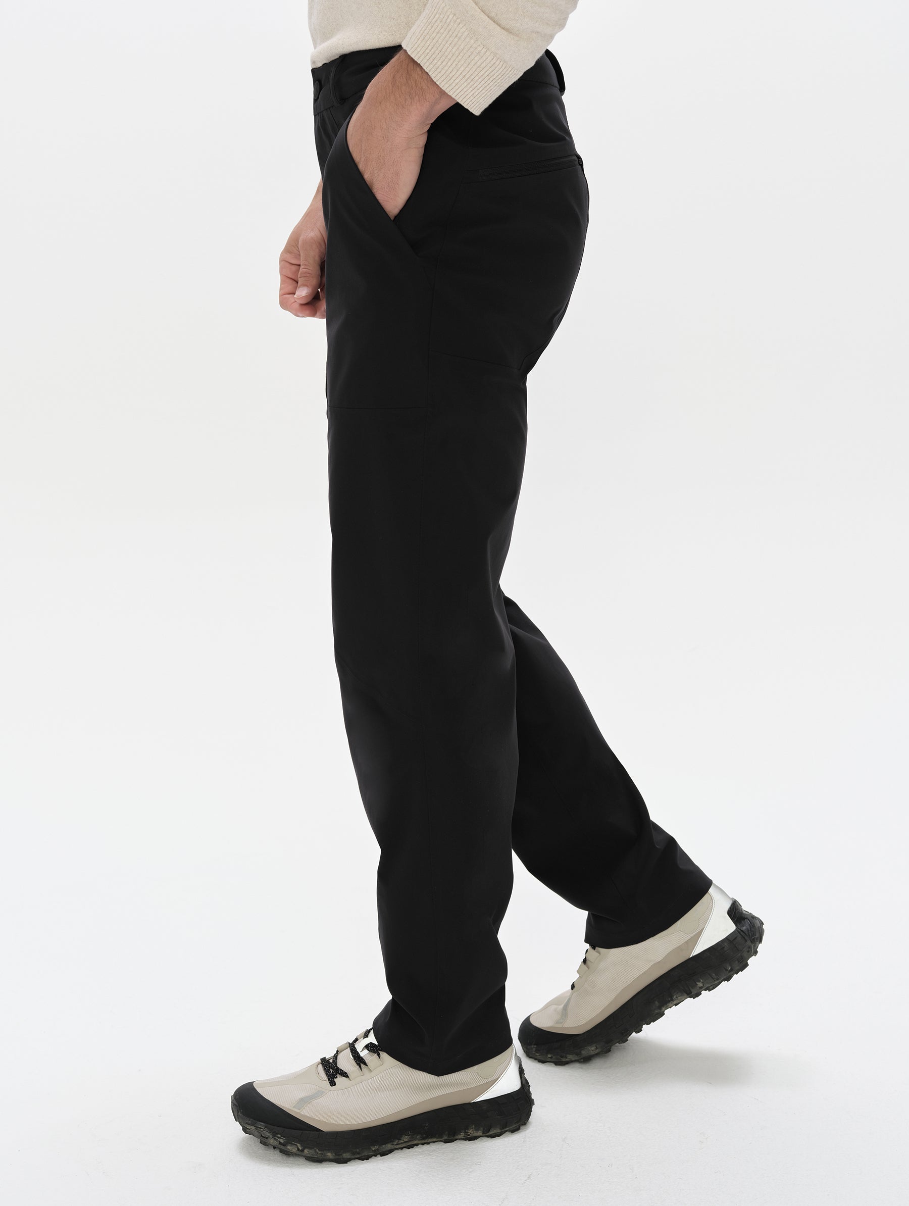 Side profile lower-body view of man wearing the Frontier Pant in Onyx Black from AETHER Apparel.