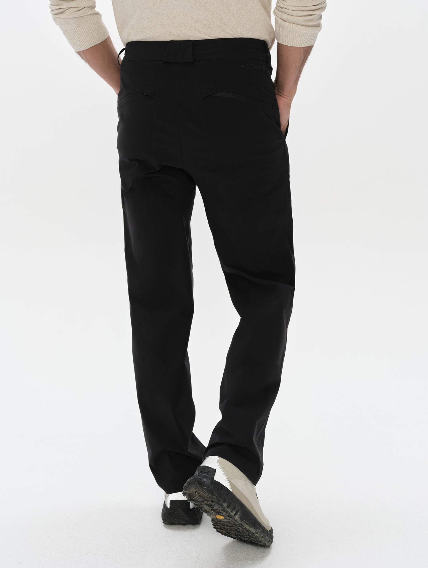 Rear lower-body view of man wearing the Frontier Pant in Onyx Black from AETHER Apparel.