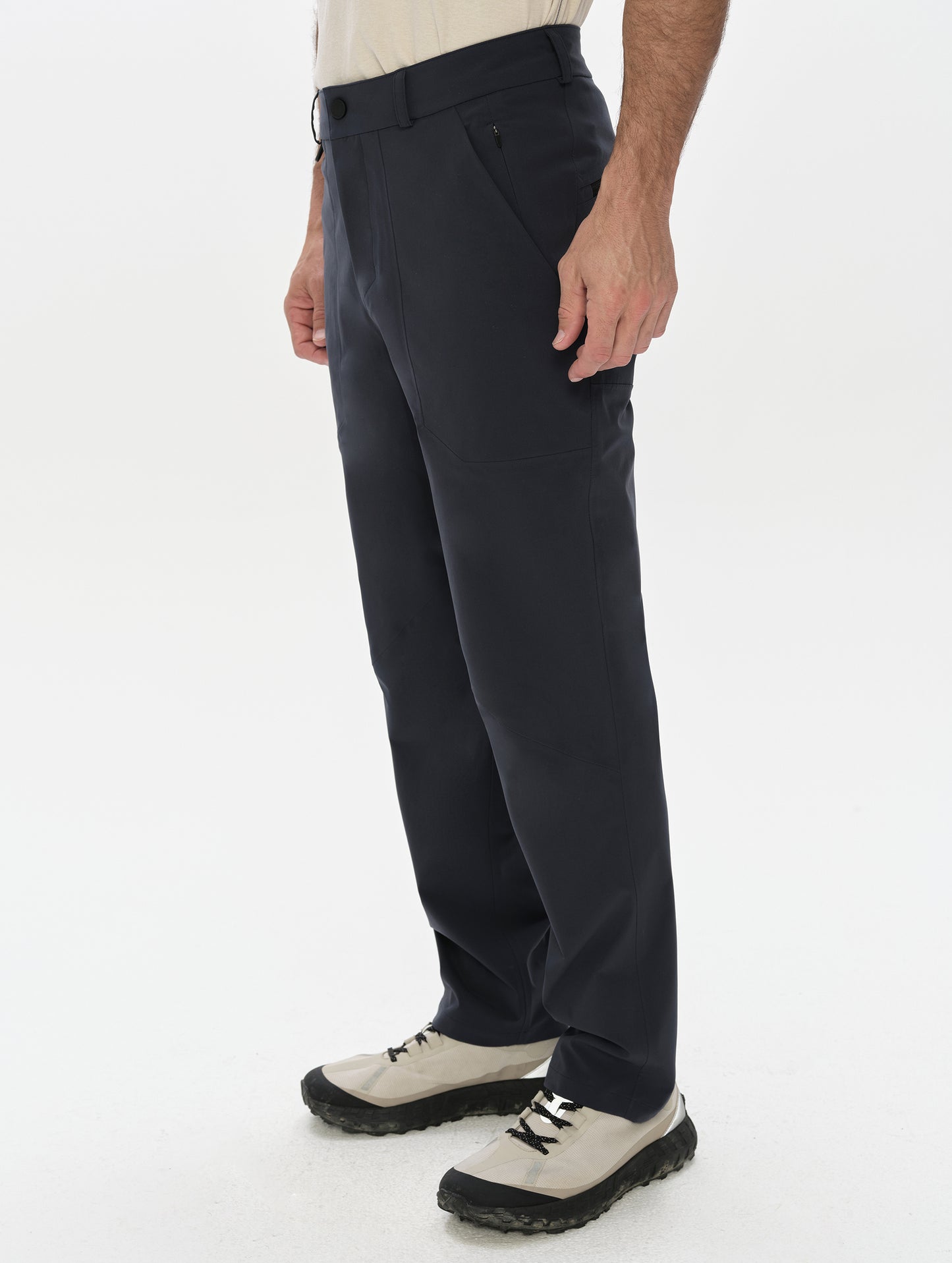 Front, 3/4, lower-body view of man wearing the Frontier Pant in Total Eclipse dark blue from AETHER Apparel.
