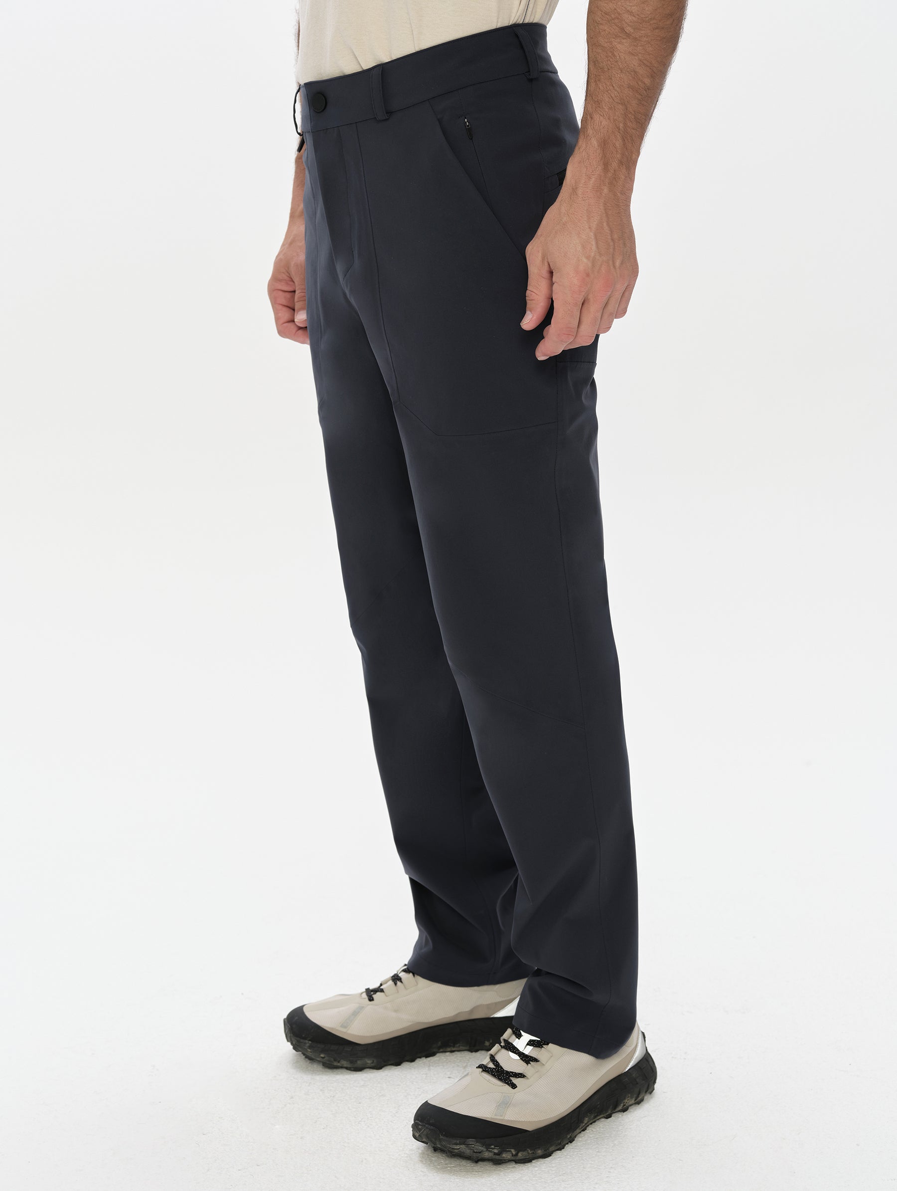 Front, 3/4, lower-body view of man wearing the Frontier Pant in Total Eclipse dark blue from AETHER Apparel.
