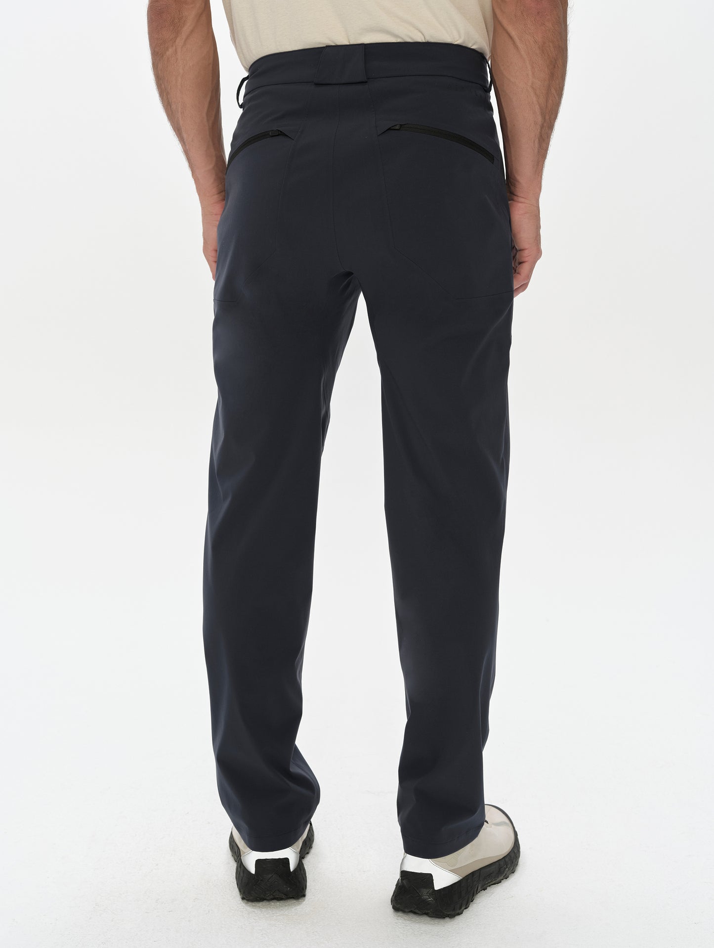 Rear, lower-body view of man wearing the Frontier Pant in Total Eclipse dark blue from AETHER Apparel.
