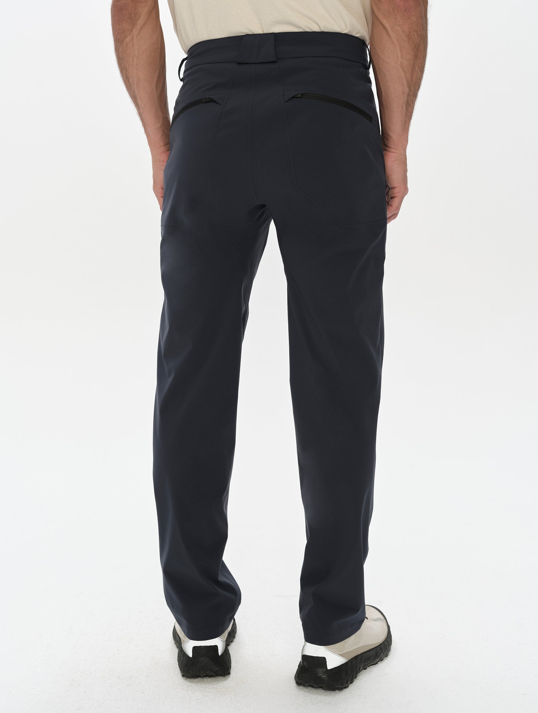 Rear, lower-body view of man wearing the Frontier Pant in Total Eclipse dark blue from AETHER Apparel.
