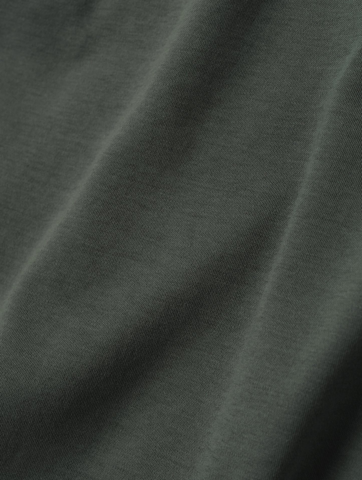 Closeup detailed view of the fabric on the Harlow Premium Long-Sleeve Tee in Saville Green from AETHER Apparel.
