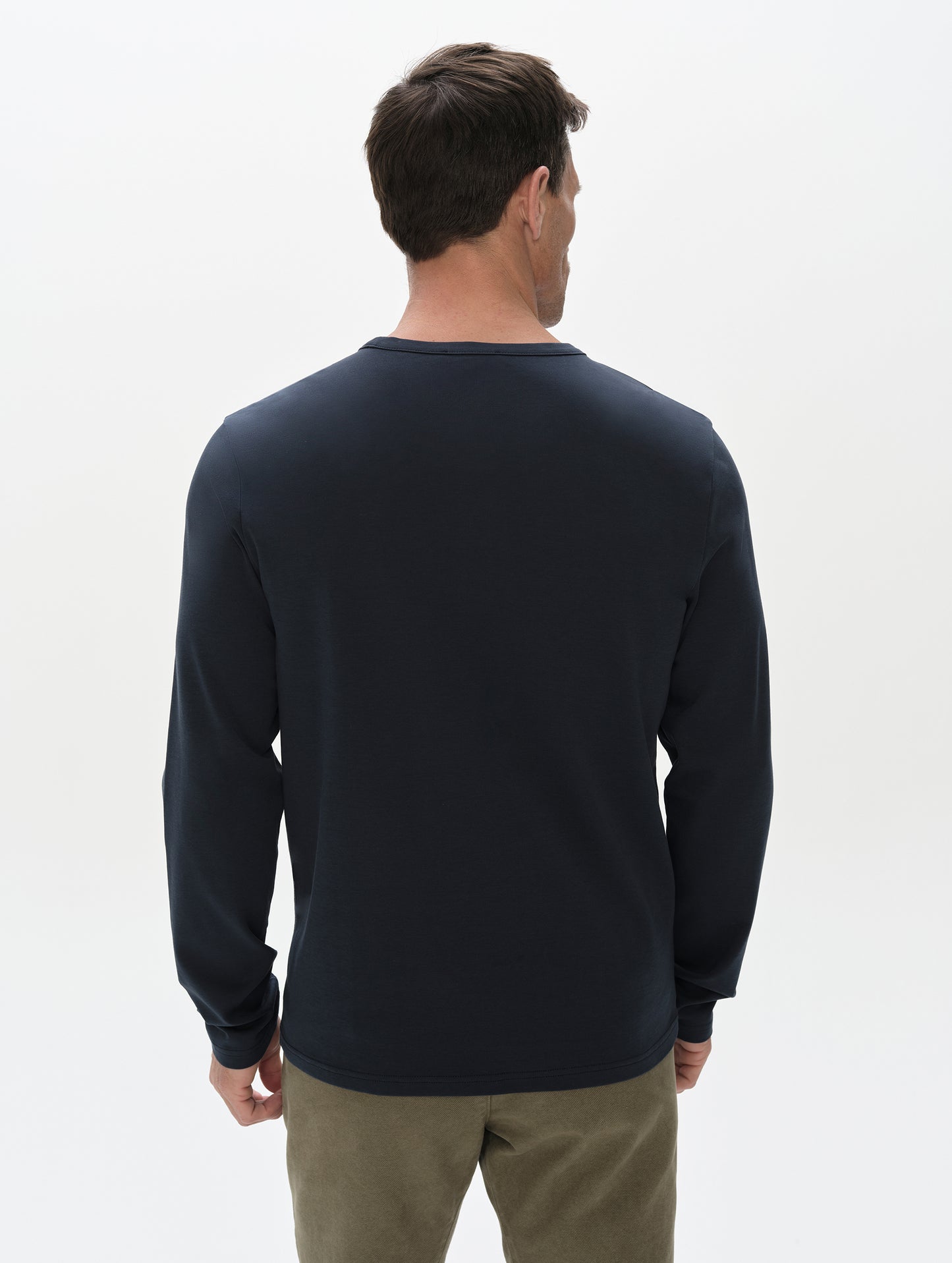 Rear, upper-body view of man wearing Harlow Premium Long-Sleeve Tee in Total Eclipse from AETHER Apparel.