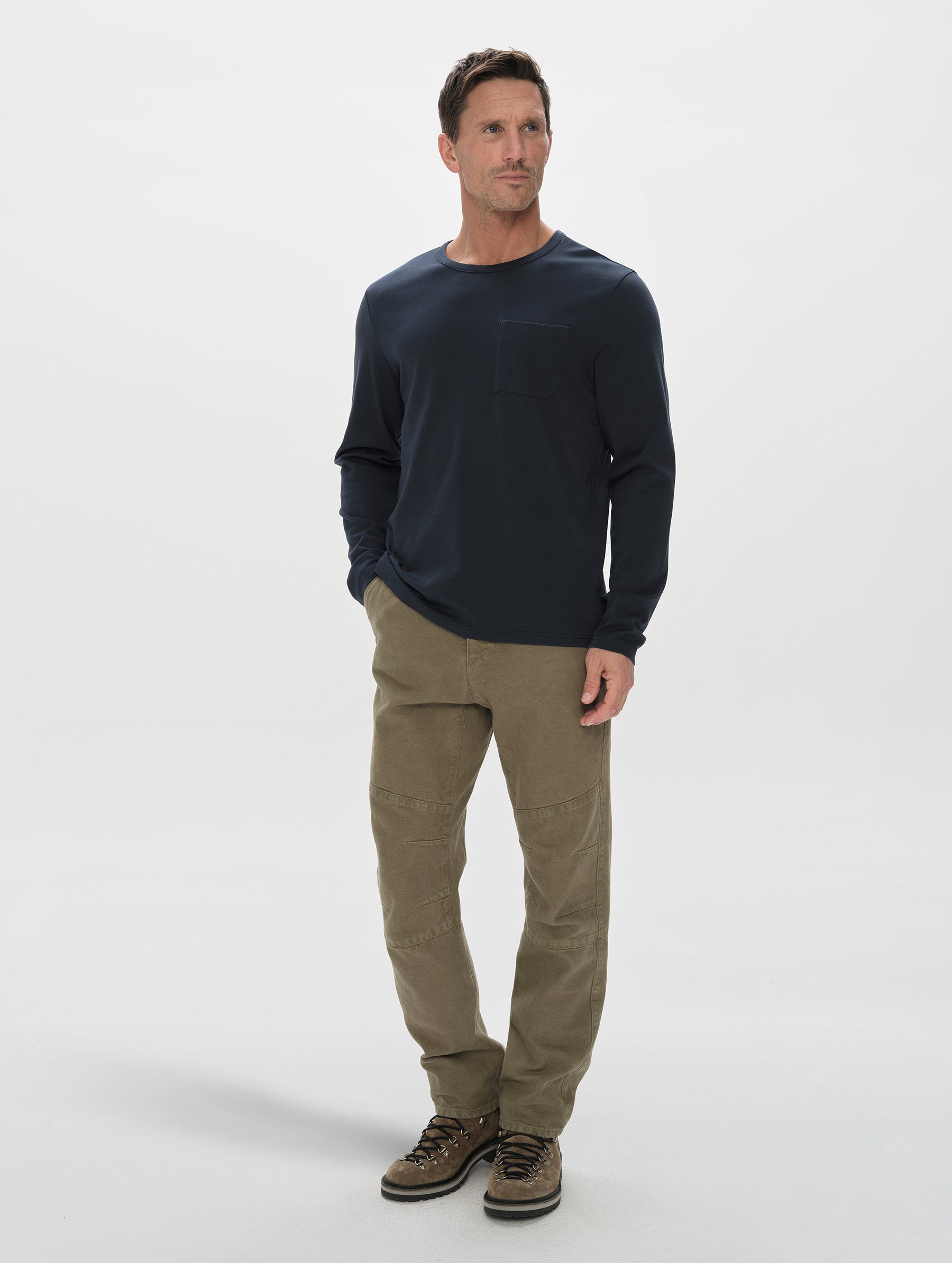 Front, full-body view of man wearing Harlow Premium Long-Sleeve Tee in Total Eclipse from AETHER Apparel.