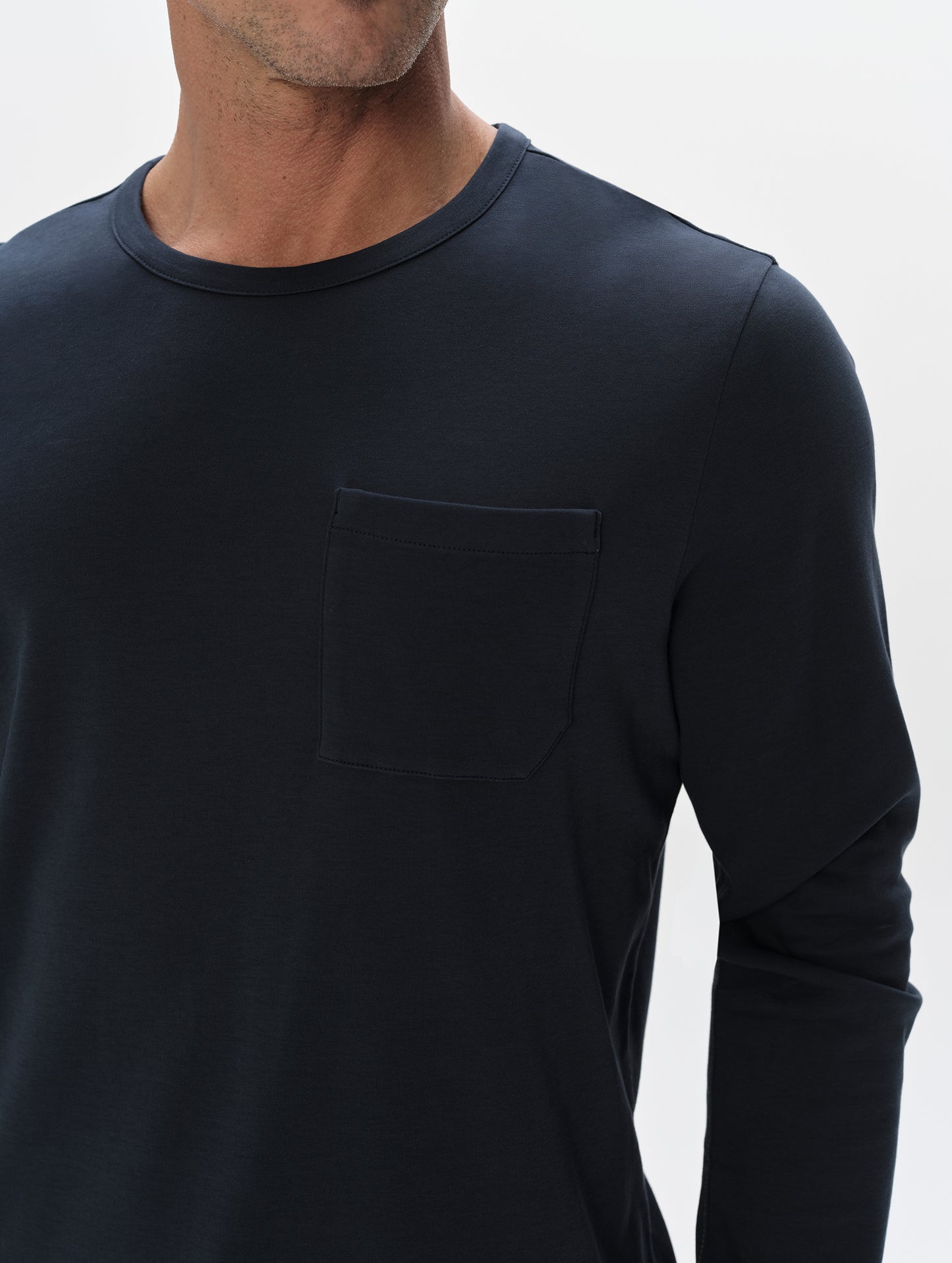 Closeup detailed view of the patch pocket and shoulder of the Harlow Premium Long-Sleeve Tee in Total Eclipse from AETHER Apparel.