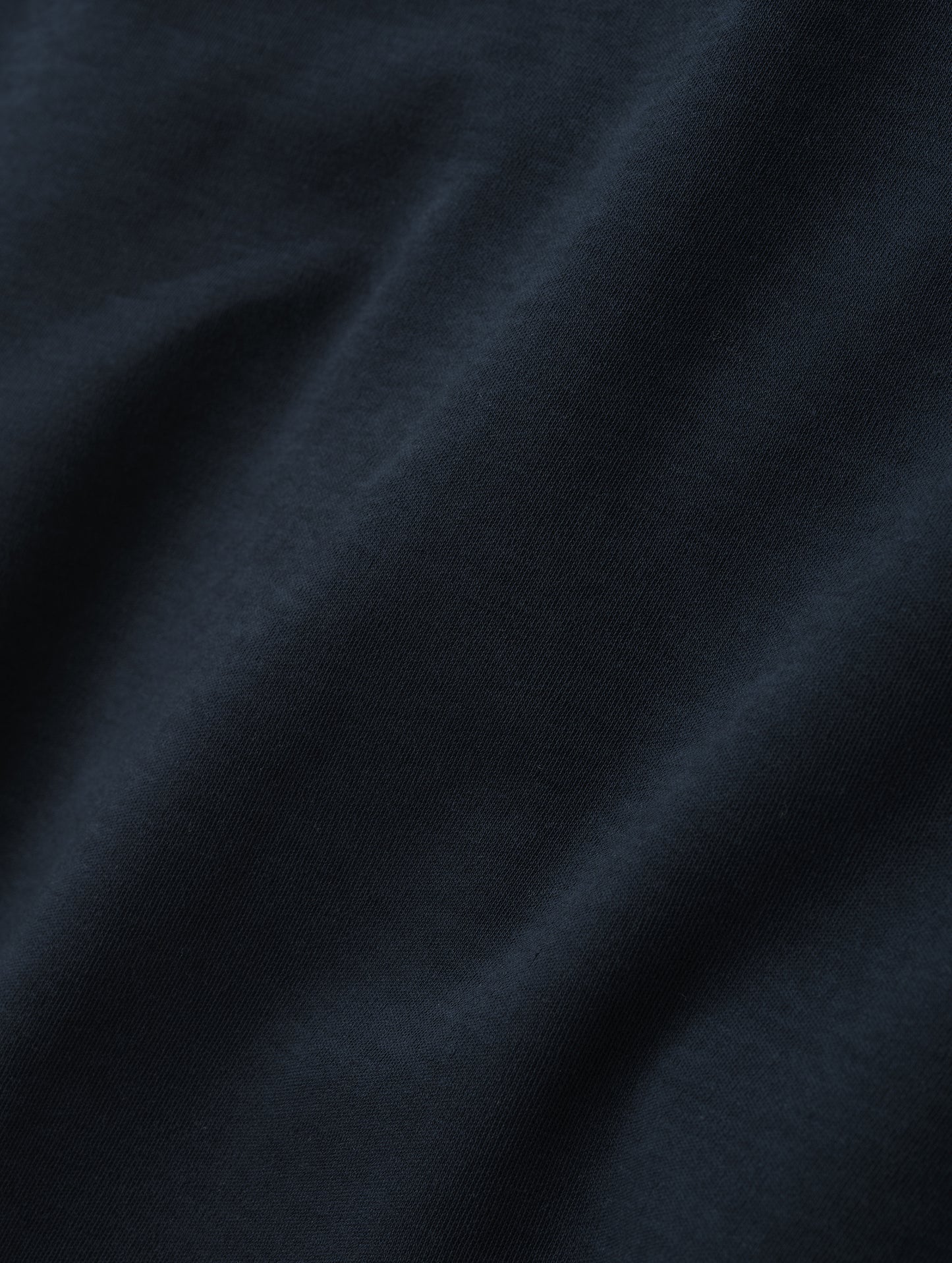 Closeup detailed view of the fabric of the Harlow Premium Long-Sleeve Tee in Total Eclipse from AETHER Apparel.