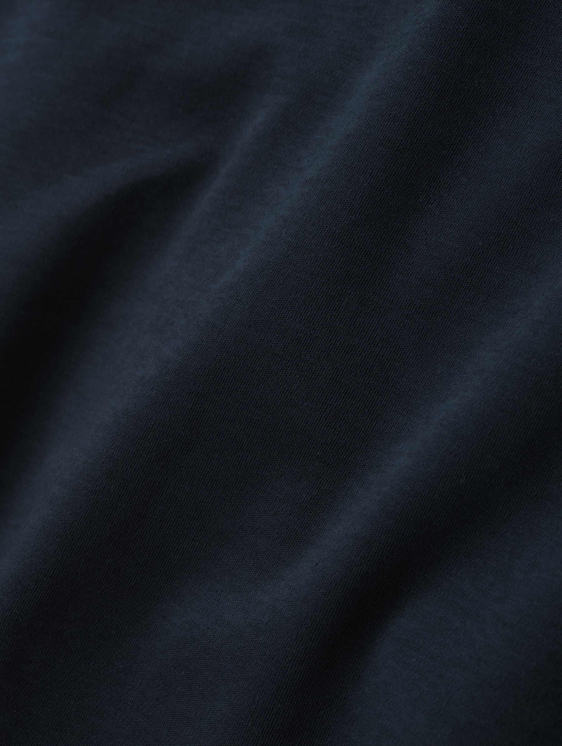 Closeup detailed view of the fabric of the Harlow Premium Long-Sleeve Tee in Total Eclipse from AETHER Apparel.