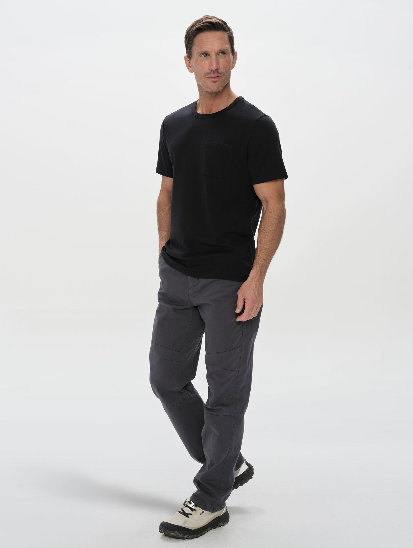 Front, full-body view of man wearing the Harlow Premium Tee in Onyx Black from AETHER Apparel.