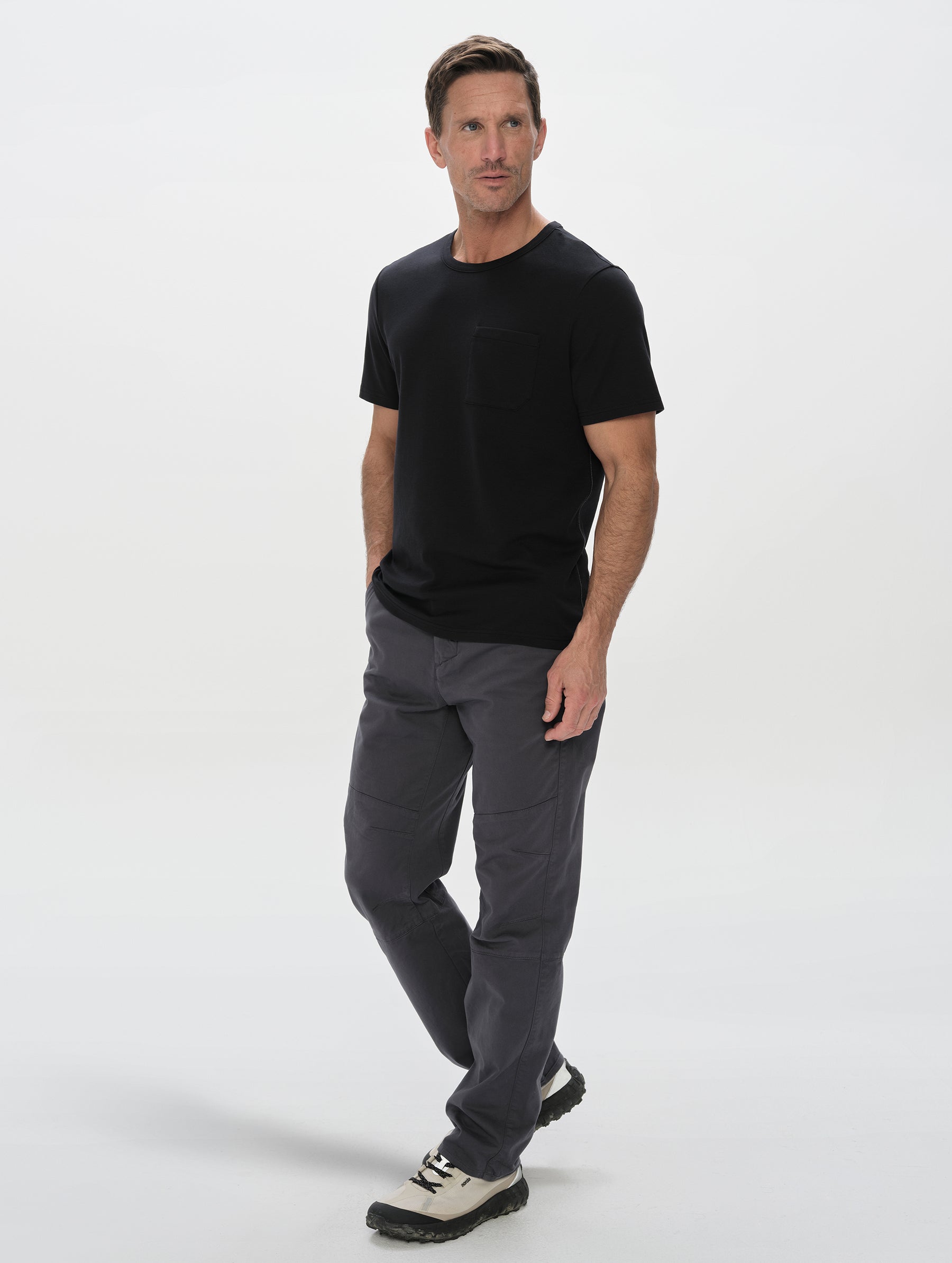 Front, full-body view of man wearing the Harlow Premium Tee in Onyx Black from AETHER Apparel.