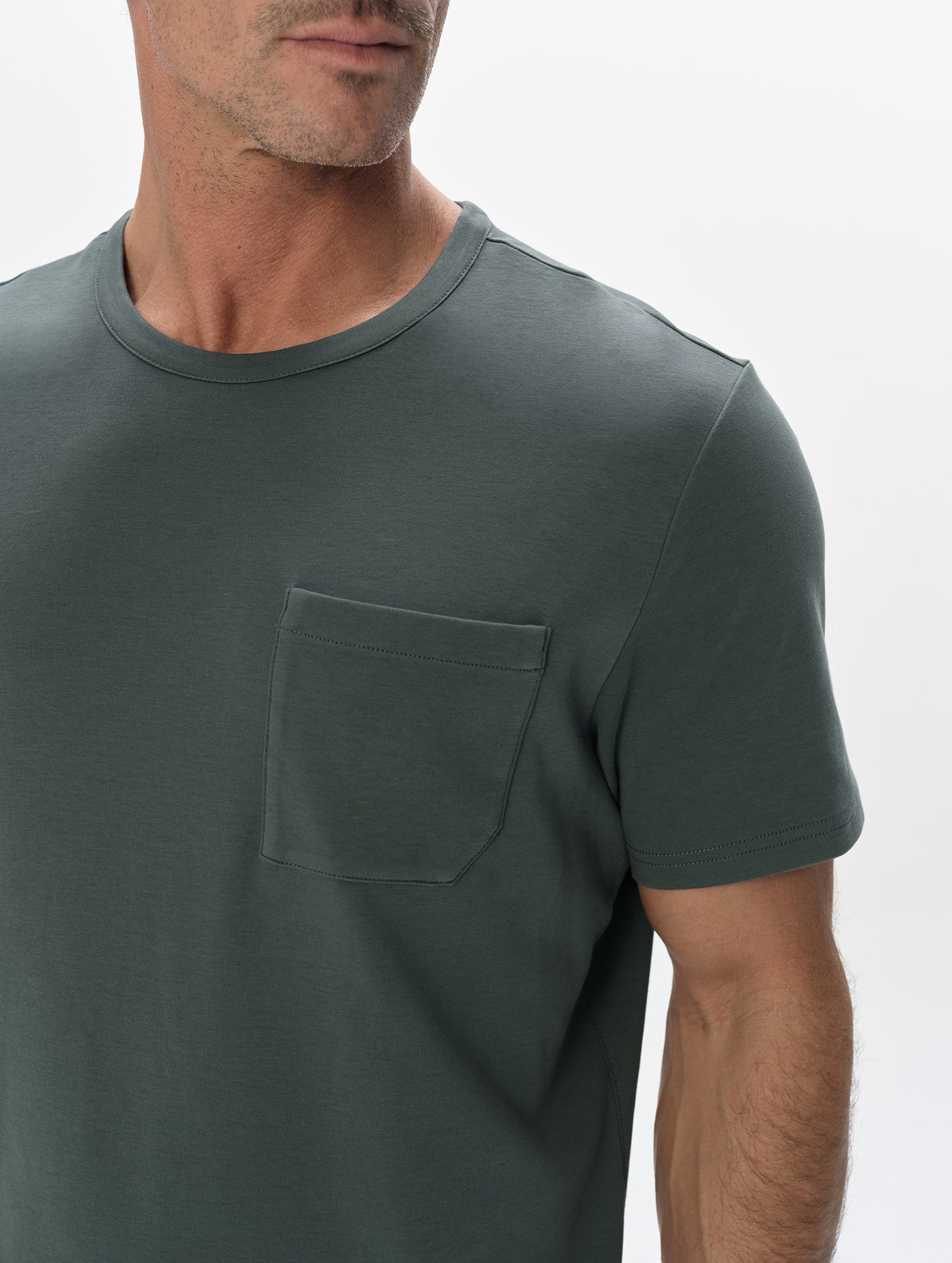 Closeup detailed view of the patch pocket and shoulder on the Harlow Premium Tee in Saville Green from AETHER Apparel.