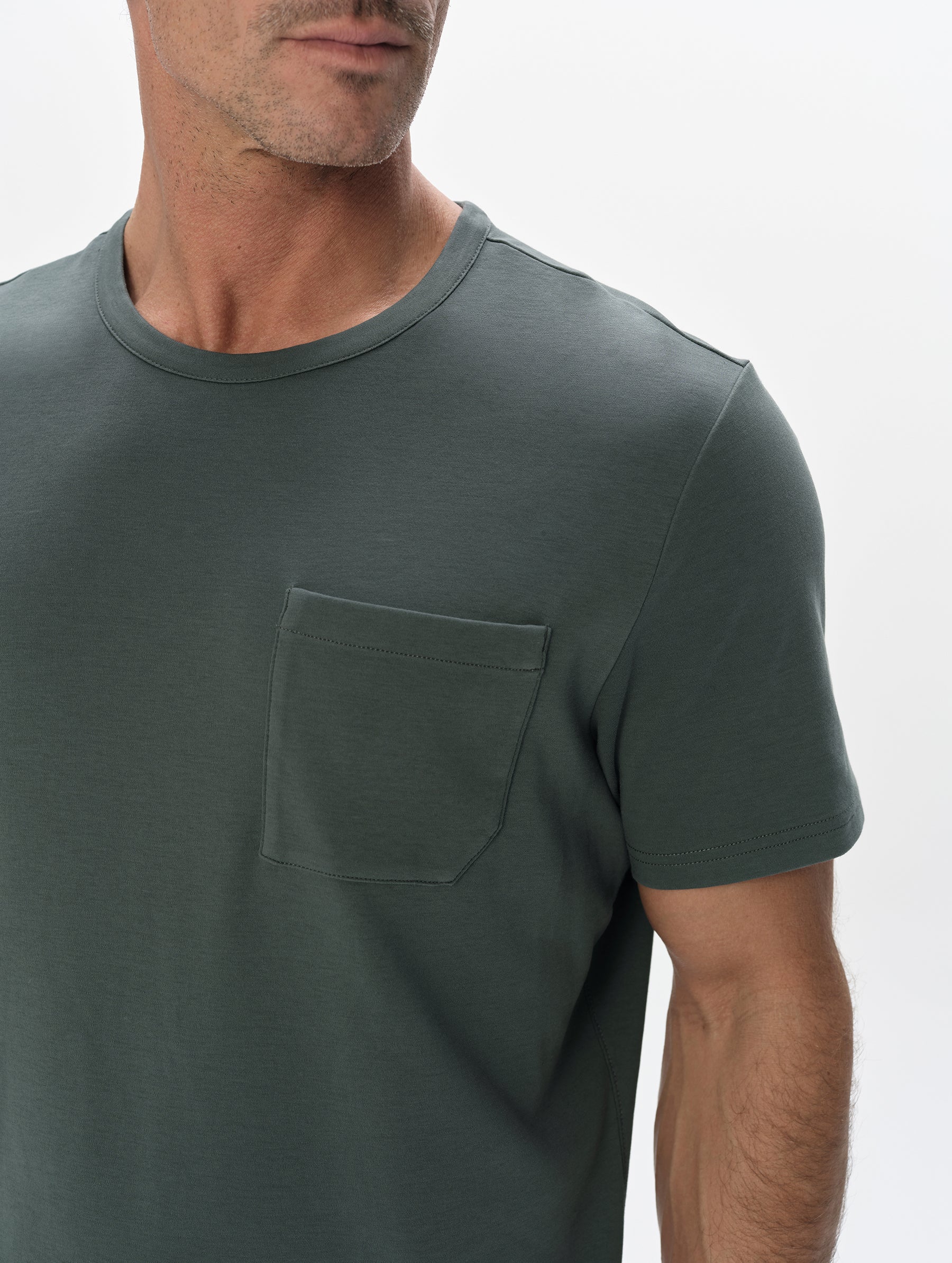 Closeup detailed view of the patch pocket and shoulder on the Harlow Premium Tee in Saville Green from AETHER Apparel.