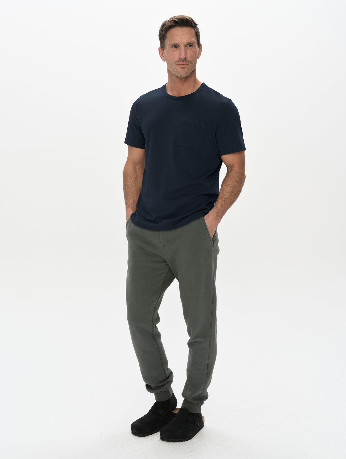 Front, full-body view of man wearing Harlow Premium Tee in Total Eclipse from AETHER Apparel.