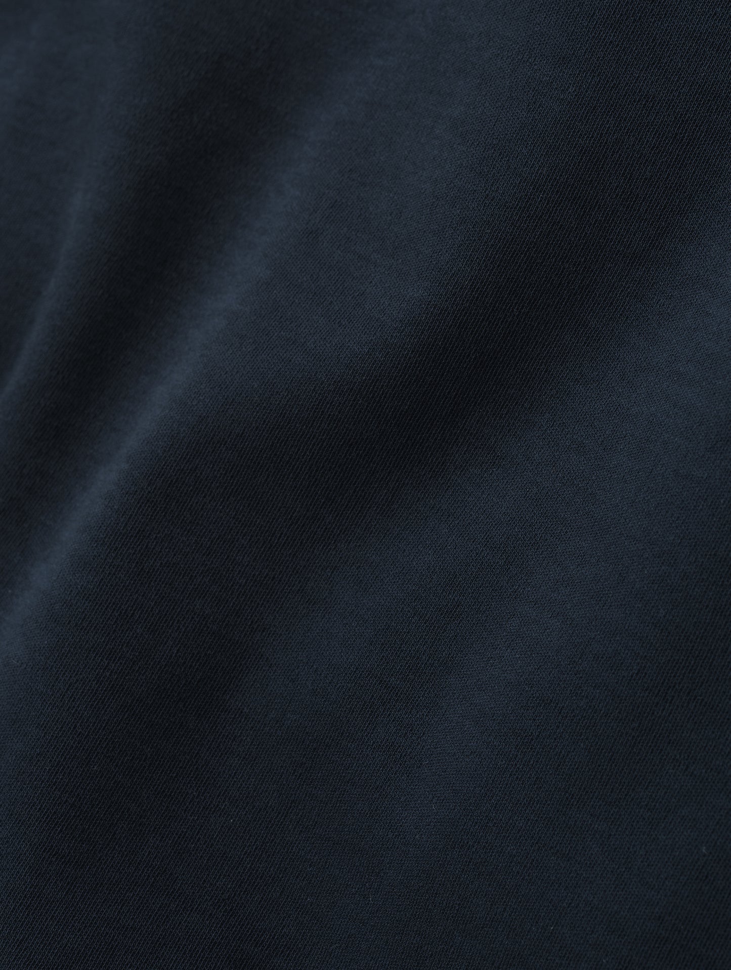 Closeup detailed view of the fabric of the Harlow Premium Tee in Total Eclipse from AETHER Apparel.