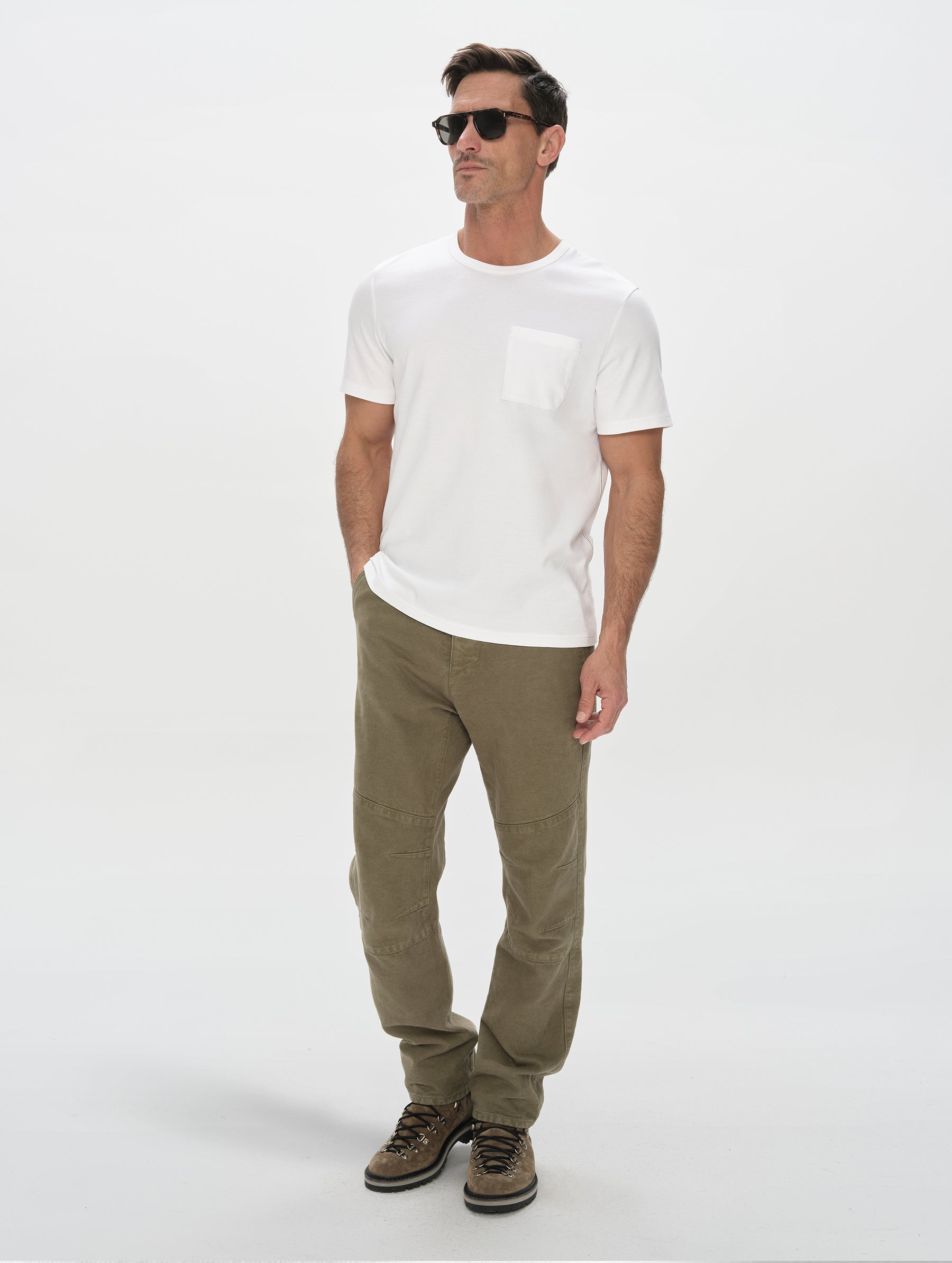 Front, full-body view of man wearing Harlow Premium Tee in White from AETHER Apparel.