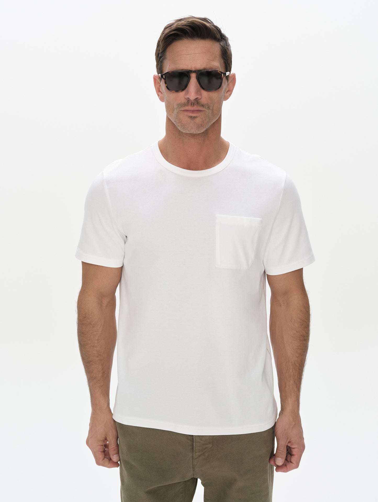 Front, upper-body view of man wearing Harlow Premium Tee in White from AETHER Apparel.