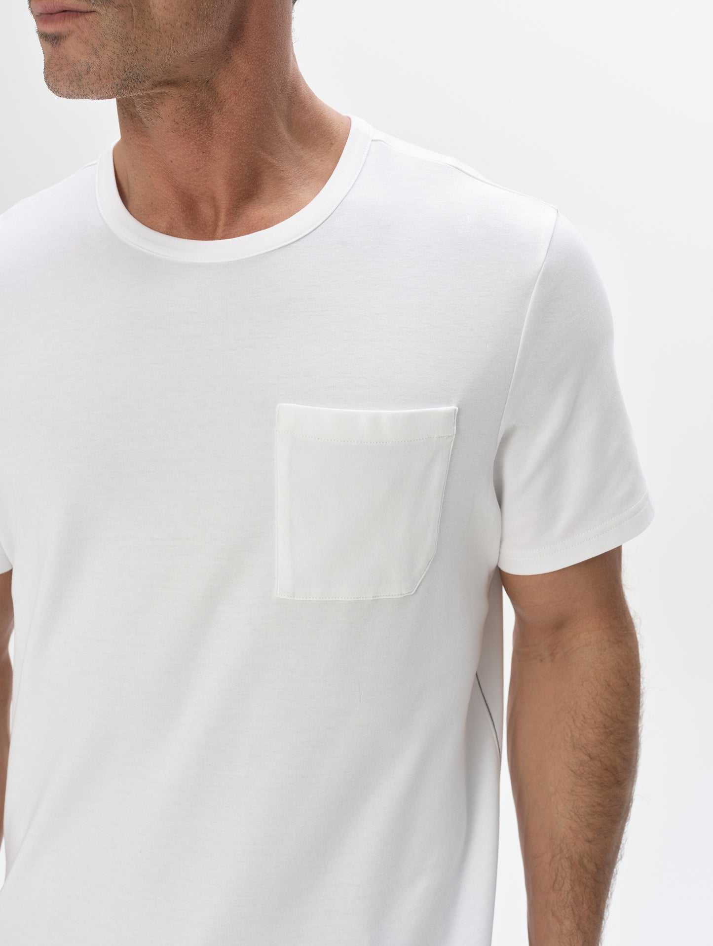Closeup detailed view of the patch pocket on the Harlow Premium Tee in White from AETHER Apparel.